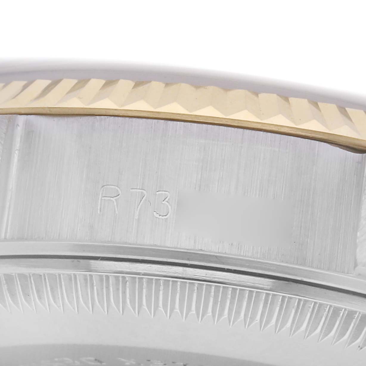 The image shows a close-up of the side of a Rolex Datejust Model 69173 men's watch, highlighting the engraved reference number and part of the fluted bezel.