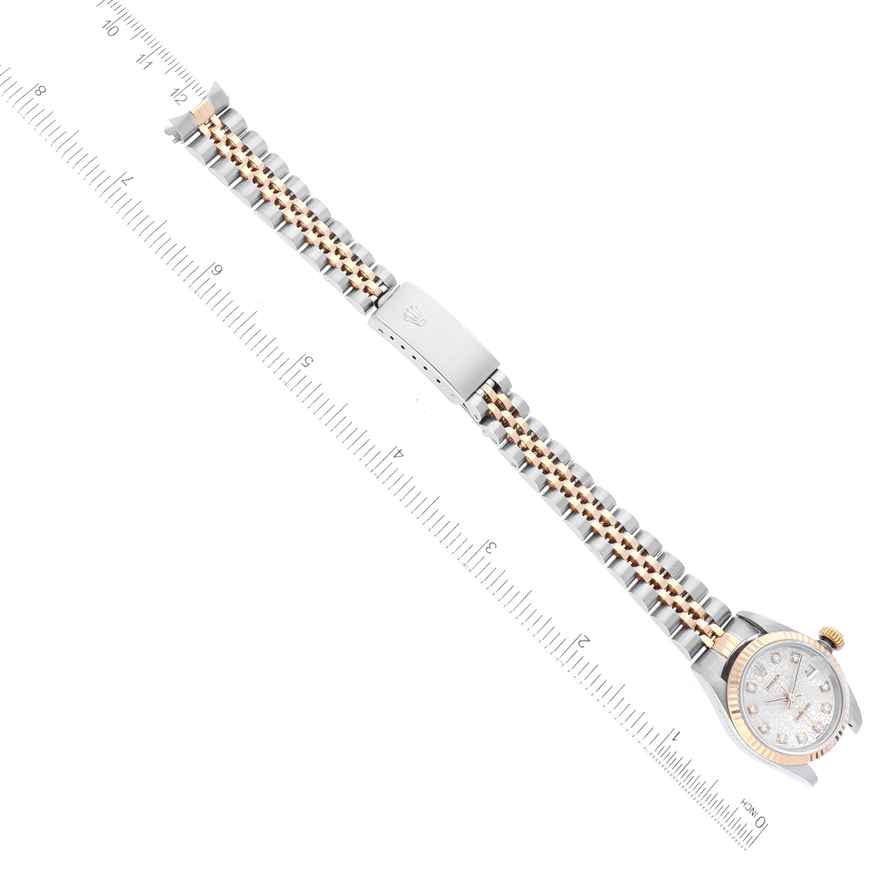 The image shows a Rolex Datejust 79173 Women's Steel and Gold (two tone) Silver Dial 79173 Women's Steel and Gold (two tone) Silver Dial watch, including the face, crown, and the two-tone Jubilee bracelet with a clasp, positioned next to a ruler.