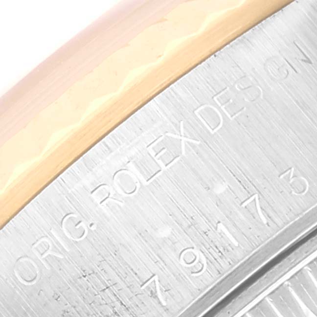 This is a close-up of the bezel and engraving on a Rolex Datejust 79173 Women's Steel and Gold (two tone) Silver Dial 79173 Women's Steel and Gold (two tone) Silver Dial watch.