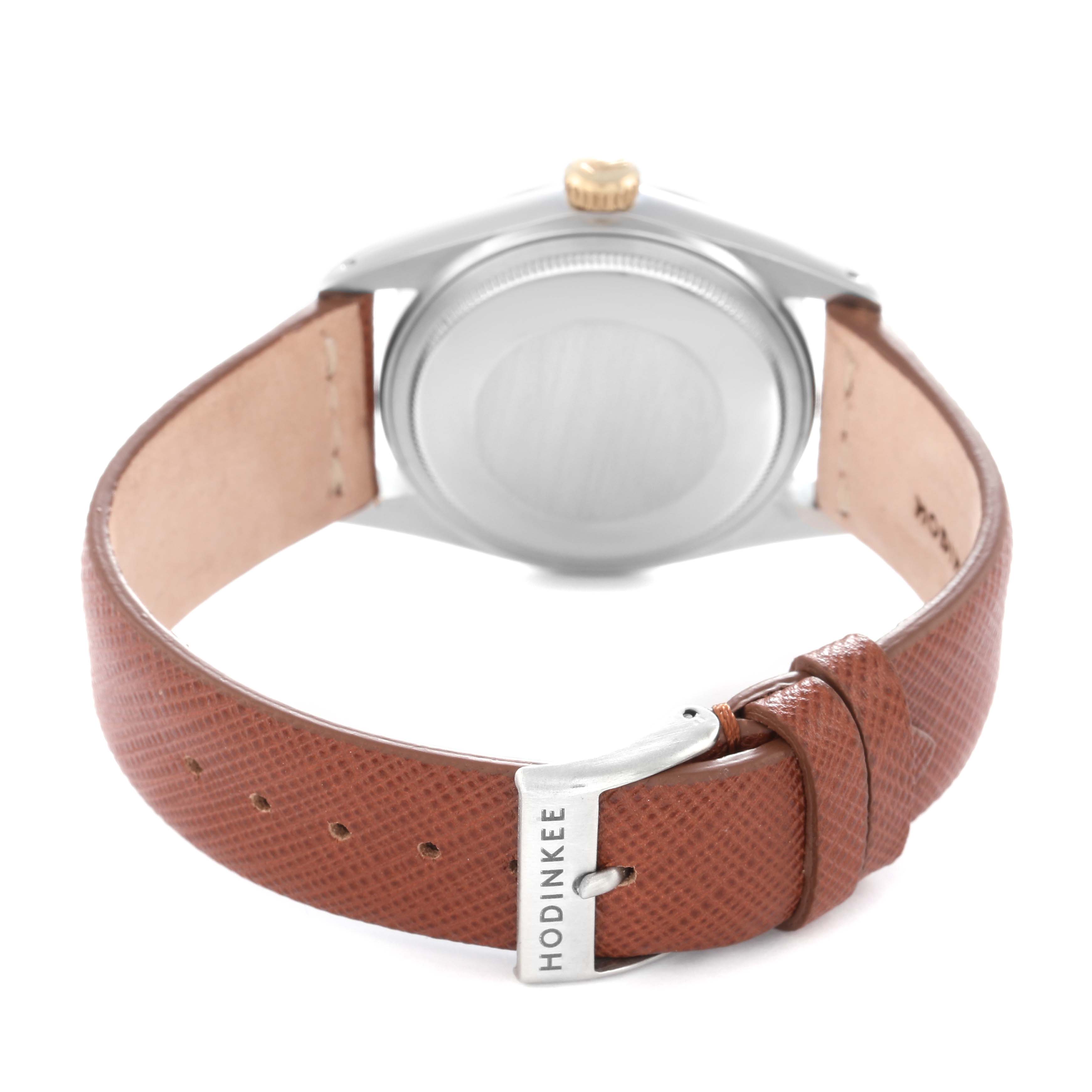 The image shows the back view of a Rolex Datejust model 16013 men's watch, highlighting its case back, crown, and a brown leather strap with a buckle.