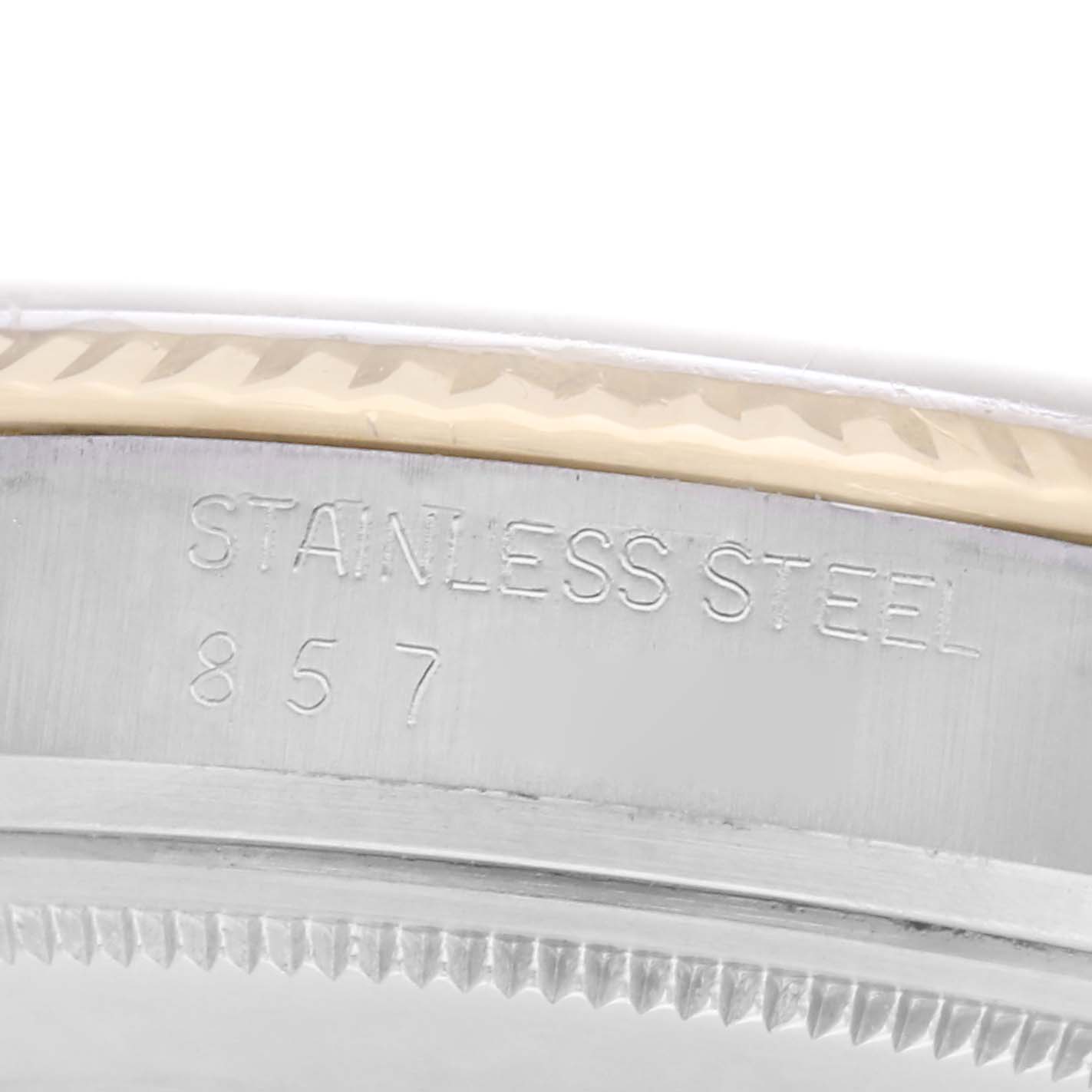 The image shows a close-up side view of a stainless steel section of a Rolex Datejust model 16013 men's watch, displaying engraved text and part of the bezel.