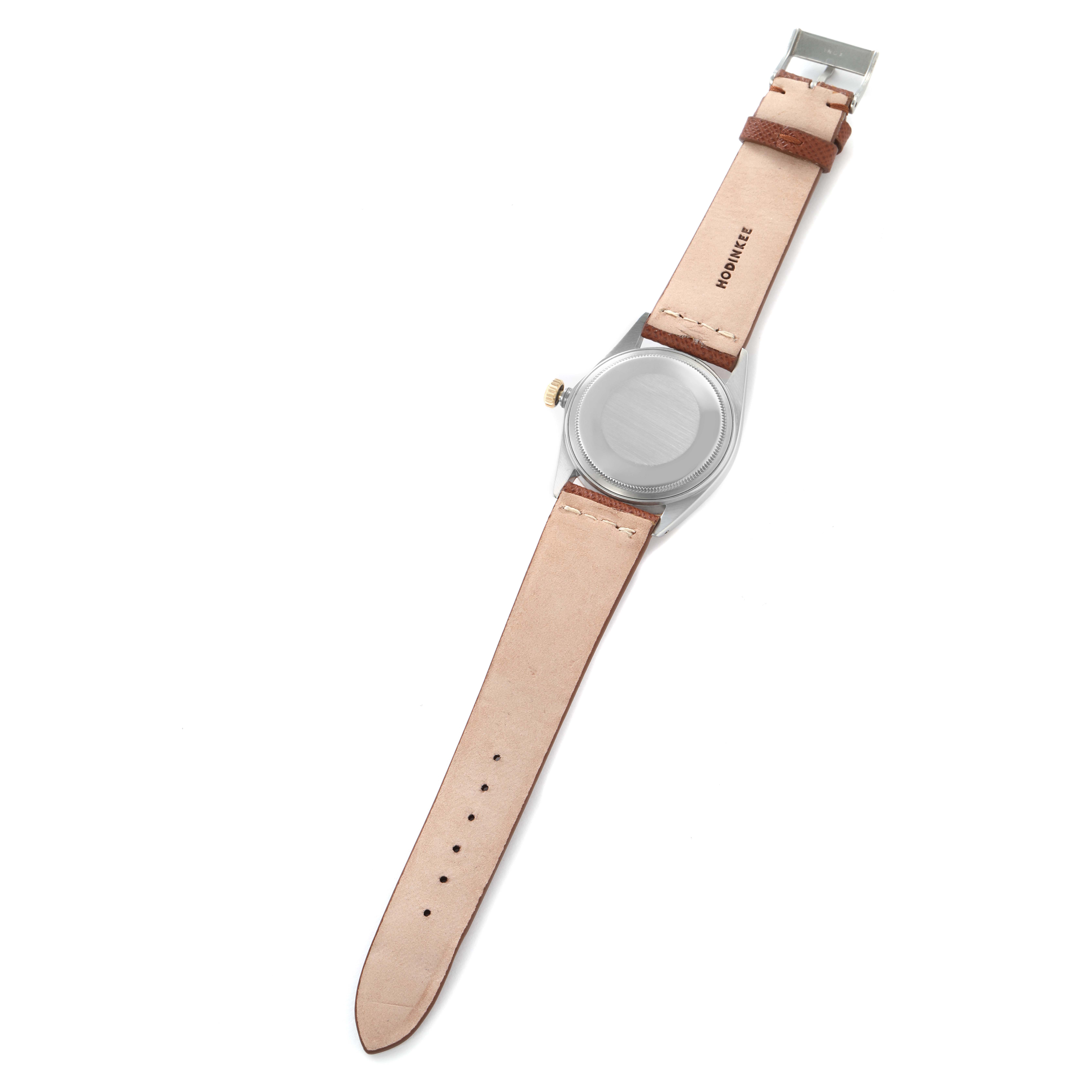 The image shows the back view of a Rolex Datejust model 16013 men's watch with a metal case and leather strap laid flat, displaying the case back and strap.