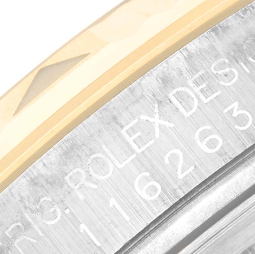 The image shows a close-up of the engraved side of the case and bezel of a Rolex Turn-o-Graph 116263 Men's Steel and Gold (two tone) Champagne Dial watch.