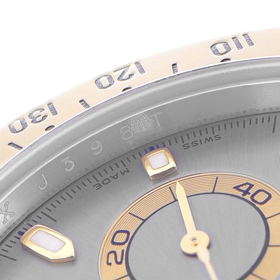 The image shows a close-up of the bezel and part of the dial of a Rolex Daytona model 116523 men's watch, highlighting the numerical markers and part of the sub-dial.