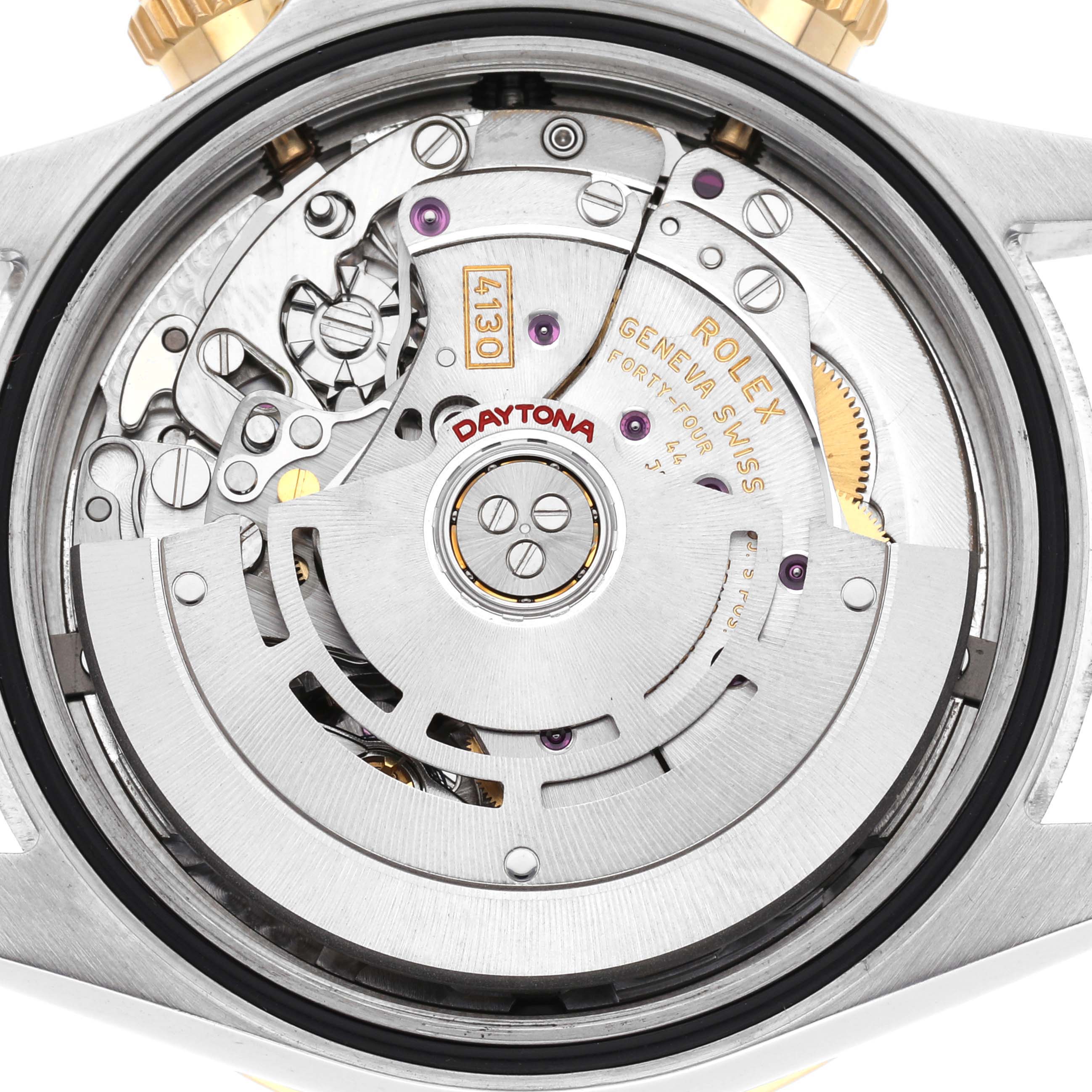 The image shows a close-up of the movement of a Rolex Daytona, model number 116523, highlighting its intricate mechanical components and engravings.