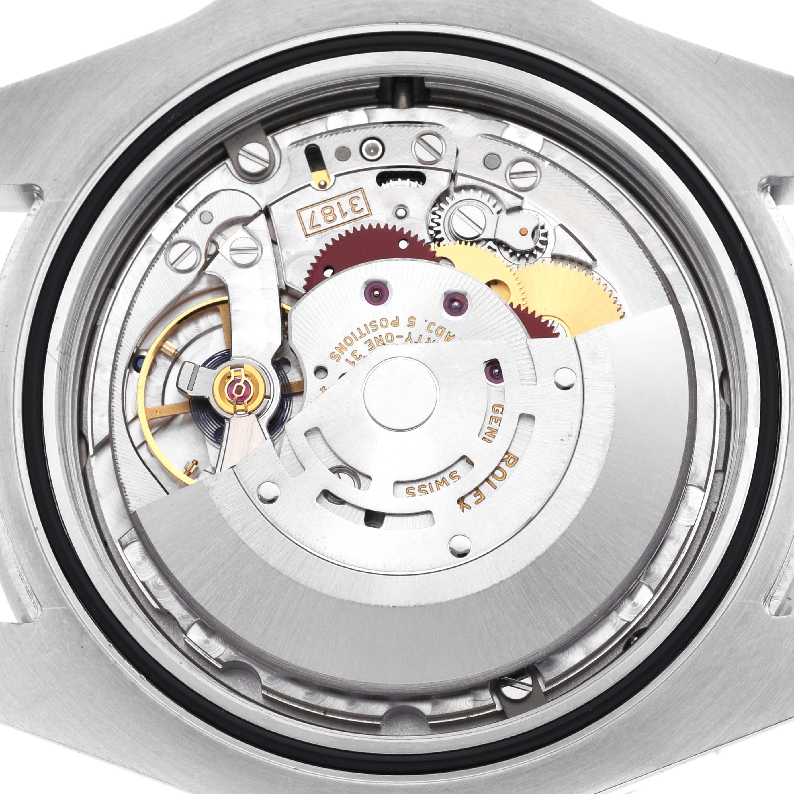 The image shows the backside of the Rolex Explorer model 216570, highlighting the intricate movement and internal mechanisms of the watch.