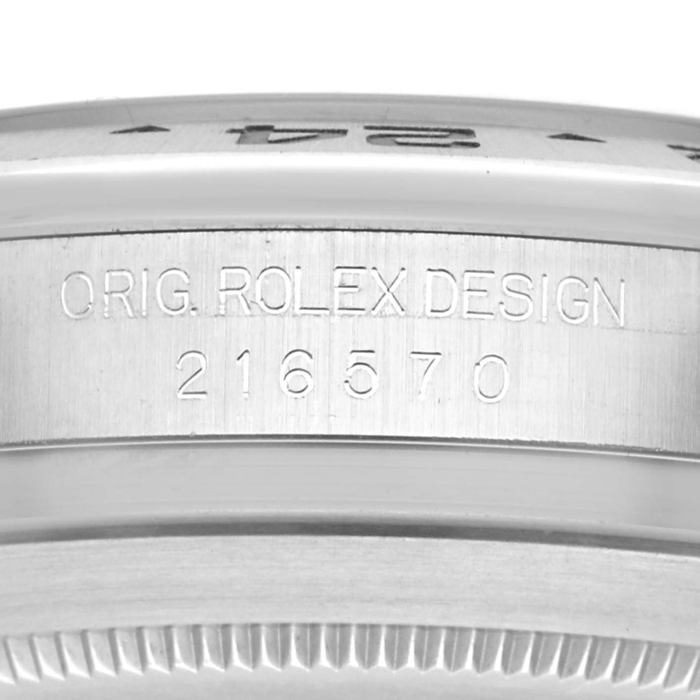 The image shows the side of a Rolex Explorer model 216570, focusing on the engraved design and model number on the watch case.