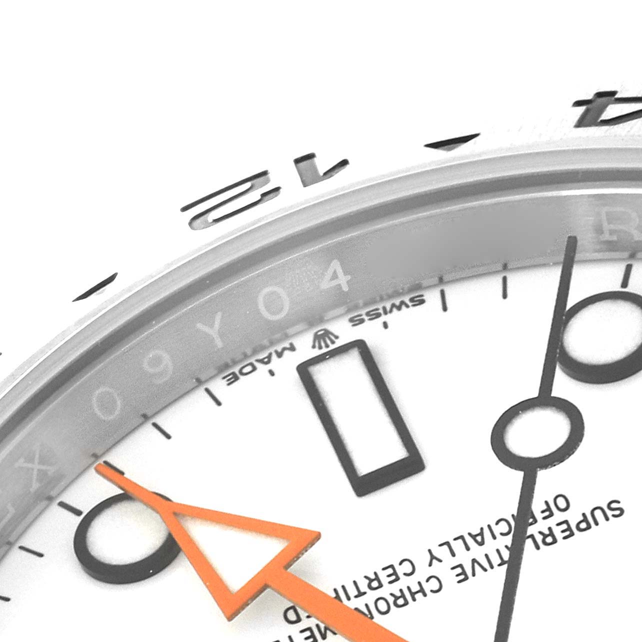 This close-up image of a Rolex Explorer 226570 Men's Stainless Steel White Dial 226570 Men's Stainless Steel White Dial watch shows part of the dial, orange hand, and "Swiss Made" text.