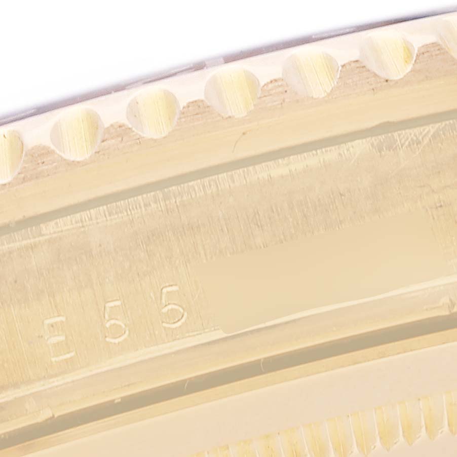 This image shows a close-up view of the engraved bezel and outer edge of a Rolex GMT-Master 16718 Men's Yellow Gold Black Dial 16718 Men's Yellow Gold Black Dial watch.