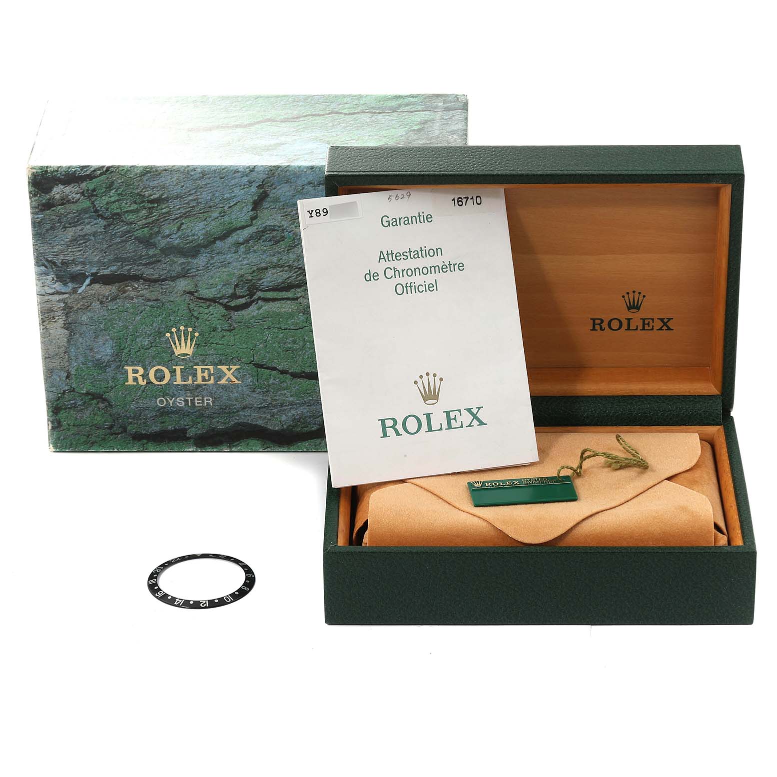 The image shows the packaging, warranty, and tag of a Rolex GMT-Master 16710 Men
s Stainless Steel Black Dial 16710 Men
s Stainless Steel Black Dial watch with a separate bezel insert.