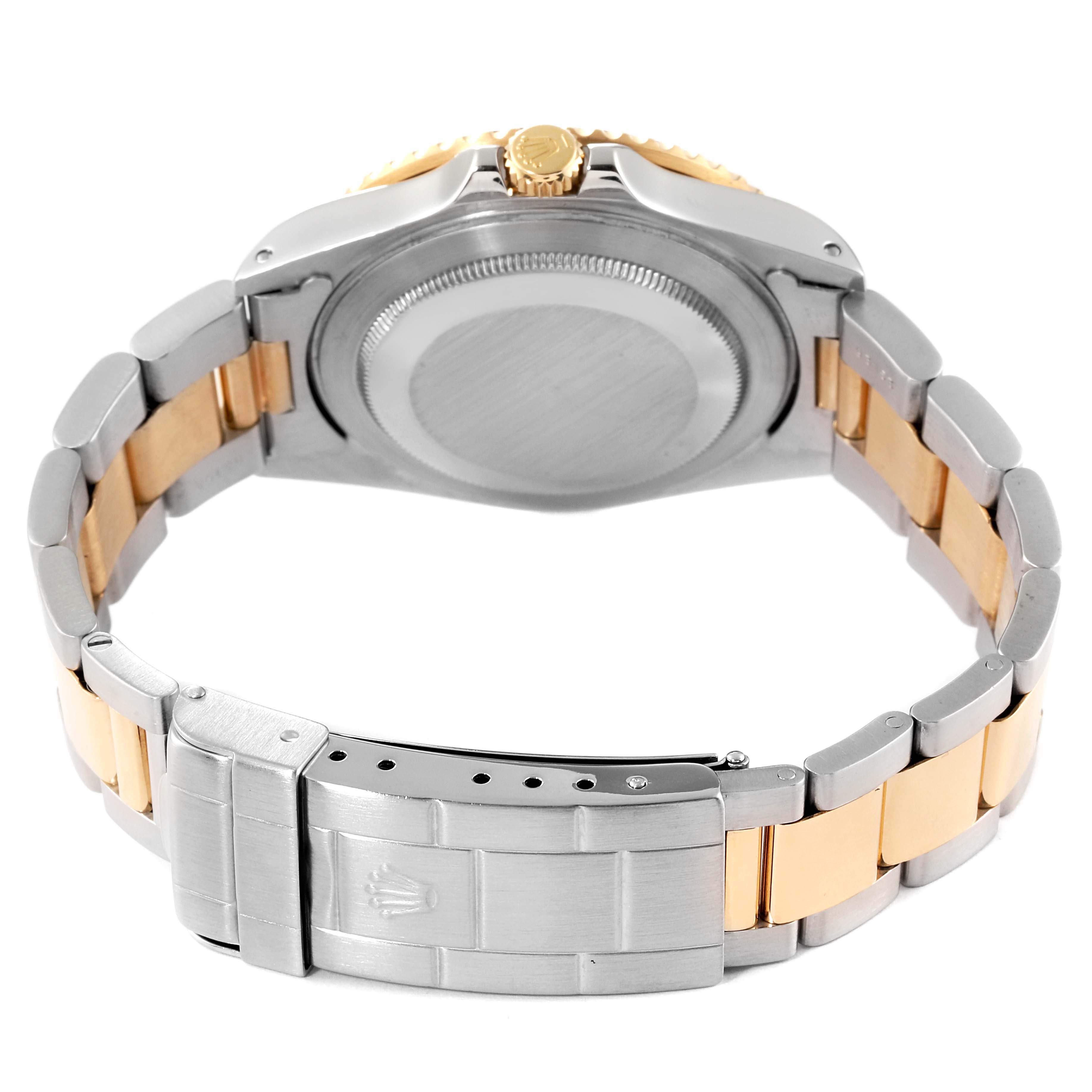 This image shows the back case and bracelet of a Rolex GMT-Master 16713 Men's Steel and Gold (two tone) Brown Dial 16713 Men's Steel and Gold (two tone) Brown Dial watch, including its clasp and crown.