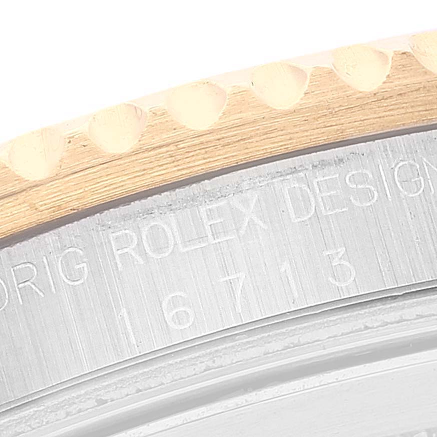 This image shows a close-up of the bezel and case side of a Rolex GMT-Master 16713 Men's Steel and Gold (two tone) Brown Dial 16713 Men's Steel and Gold (two tone) Brown Dial, with the model number 16713 engraved.