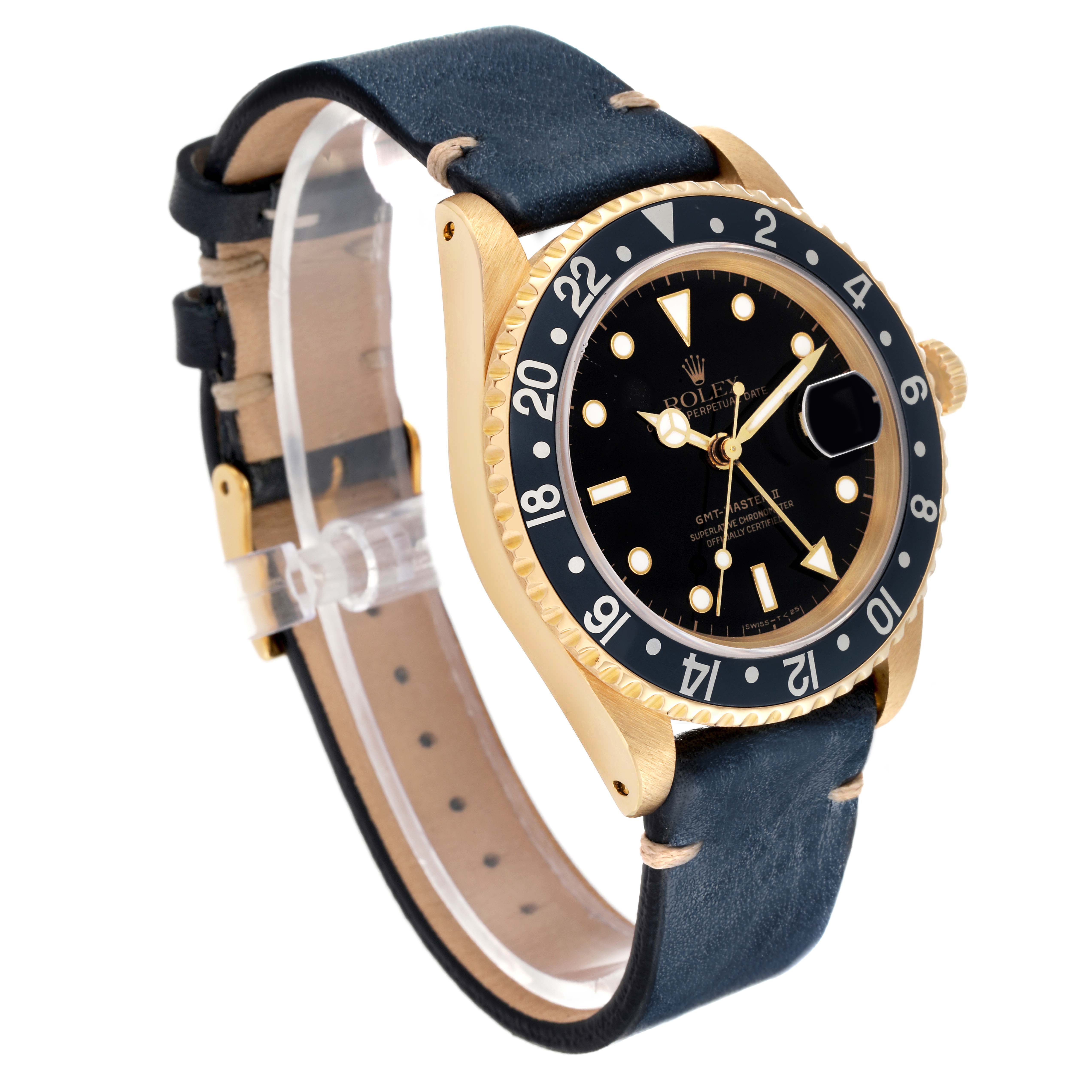 The Rolex GMT-Master 16718 Men's Yellow Gold Black Dial watch is shown at an angle displaying the face, bezel, crown, and leather strap.