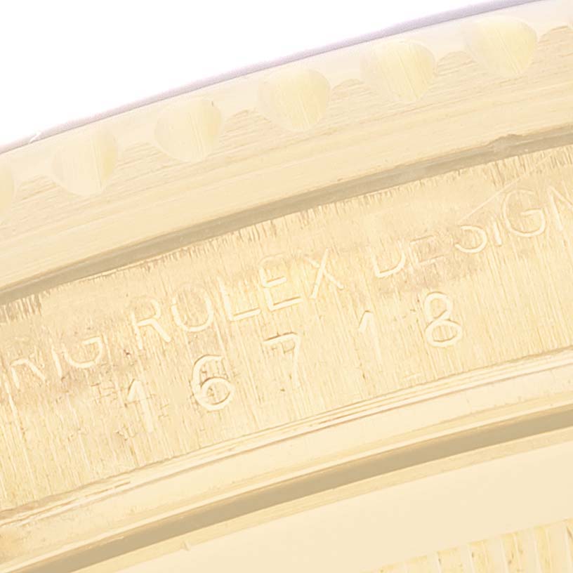 The image shows a close-up of the Rolex GMT-Master 16718 Men's Yellow Gold Black Dial, focusing on the engraved inner case and bezel edge.