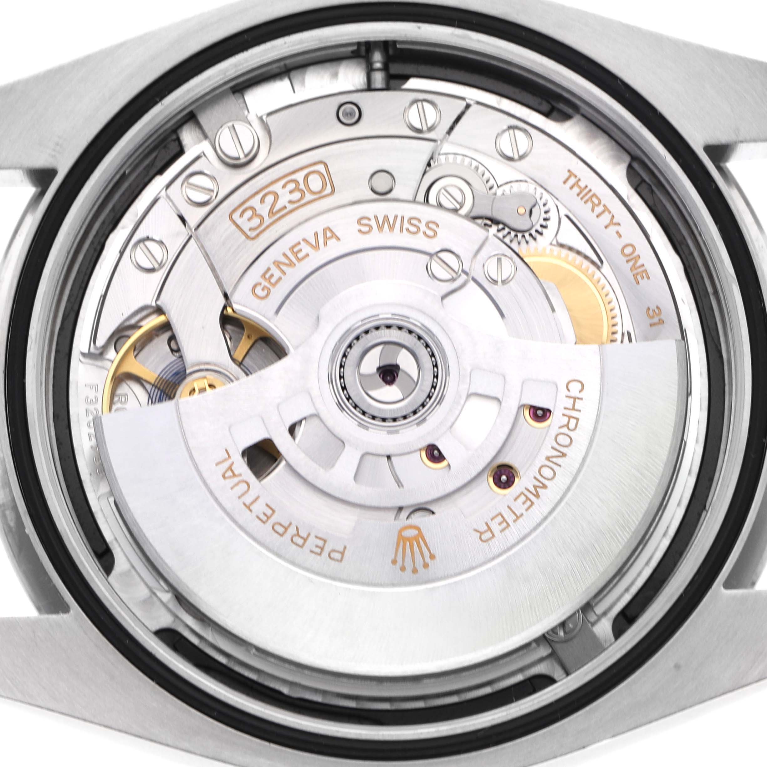 The image shows the movement of a Rolex Oyster Perpetual watch, model number 124300, viewed from the back, with visible mechanisms and engravings.