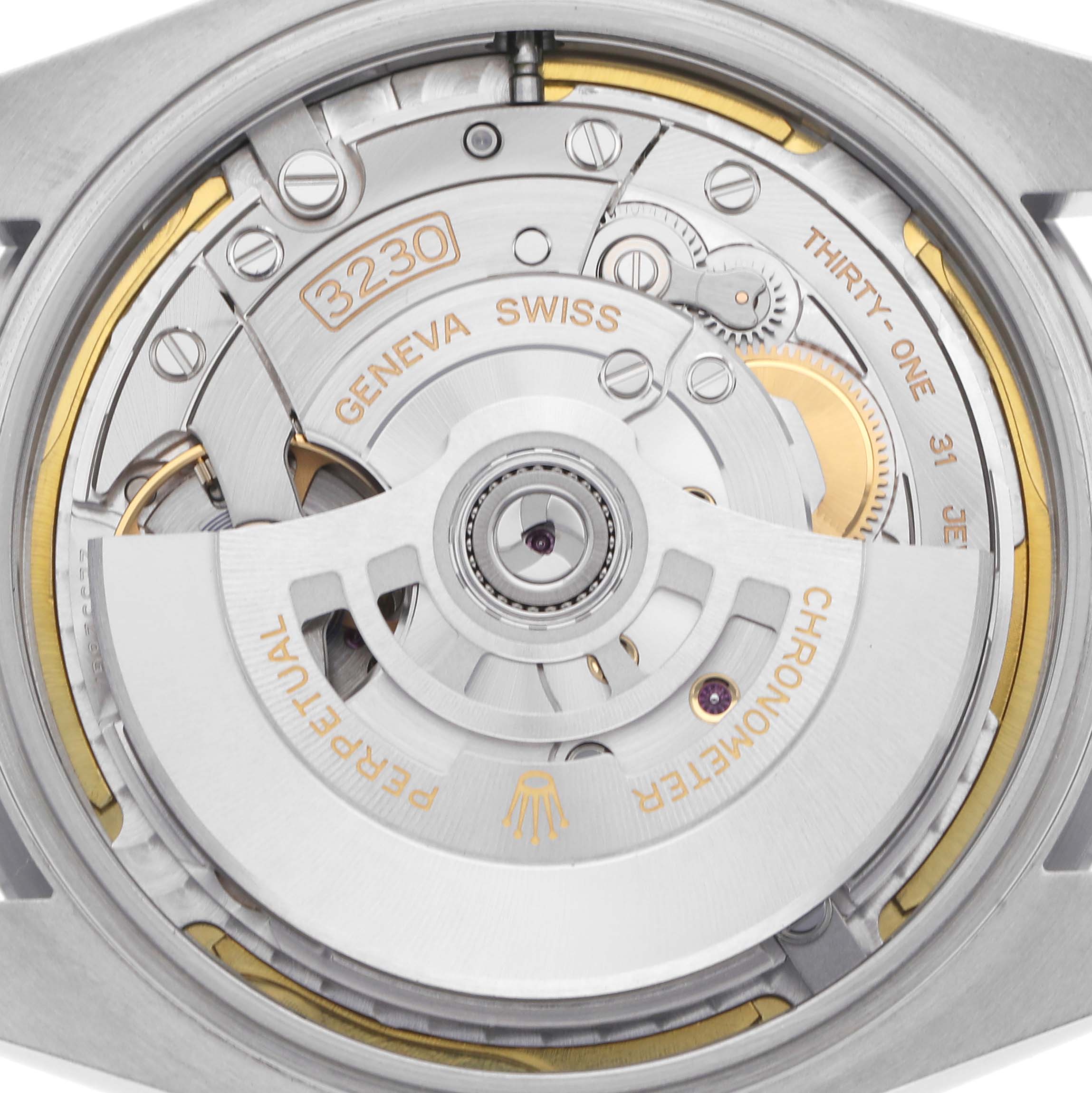 The image shows a detailed view of the movement in the back case of a Rolex Oyster Perpetual model 124300 men's watch, highlighting its mechanical components.