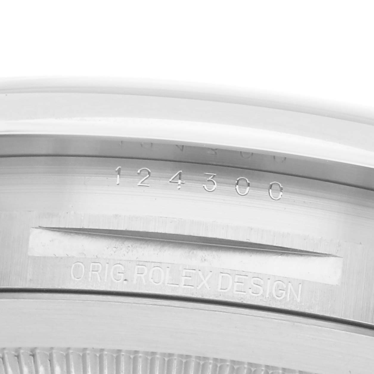 The image shows a close-up of the case back edge of the Rolex Oyster Perpetual, model number 124300, highlighting the engraved model number and "ORIG. ROLEX DESIGN."