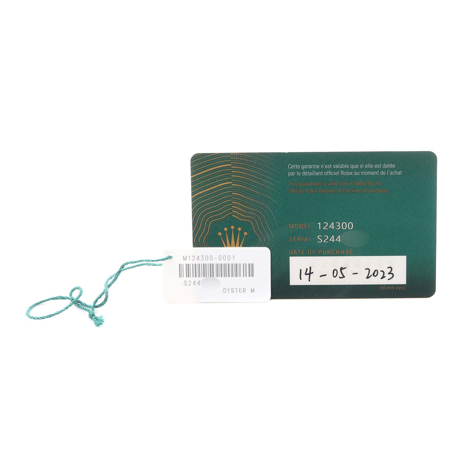 The image shows a warranty card with model number 124300 for a Rolex Oyster Perpetual men's watch alongside a tag with a barcode and green string.