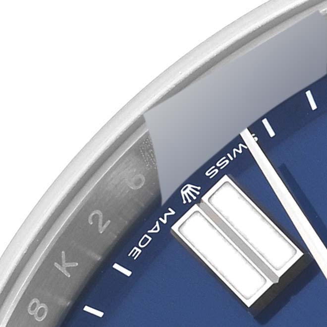 This image shows a close-up of the dial and part of the bezel of a Rolex Oyster Perpetual 124300 Men's Stainless Steel Blue Dial 124300 Men's Stainless Steel Blue Dial watch.