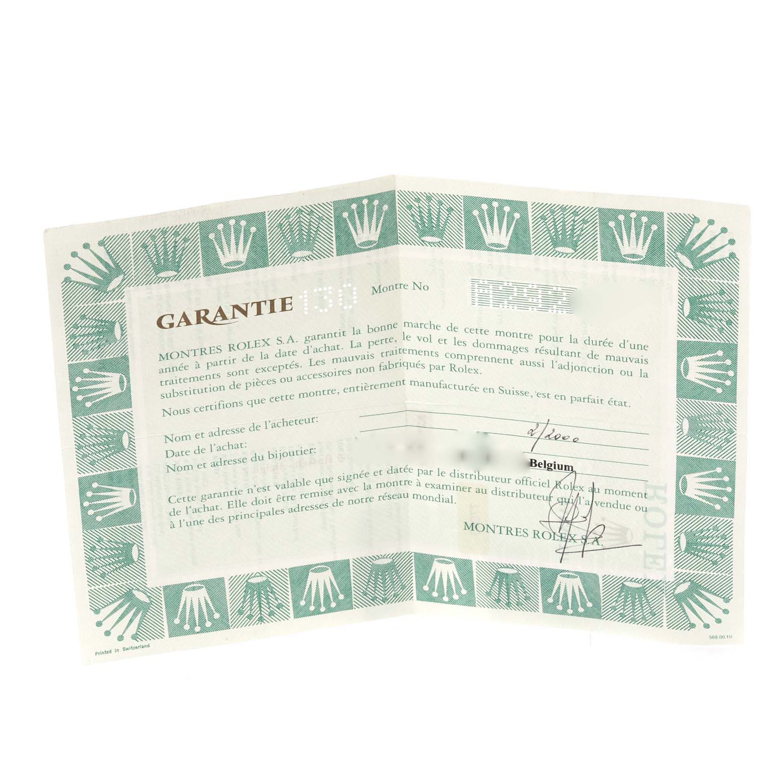 This image shows a warranty certificate for a Rolex Oyster Perpetual watch, viewed from an overhead angle.