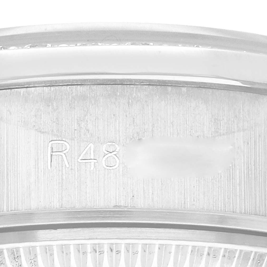 This close-up shows part of the stainless steel case and the serial number engraving of a Rolex President 69139 Women's White Gold Silver Dial 69139 Women's White Gold Silver Dial model watch.