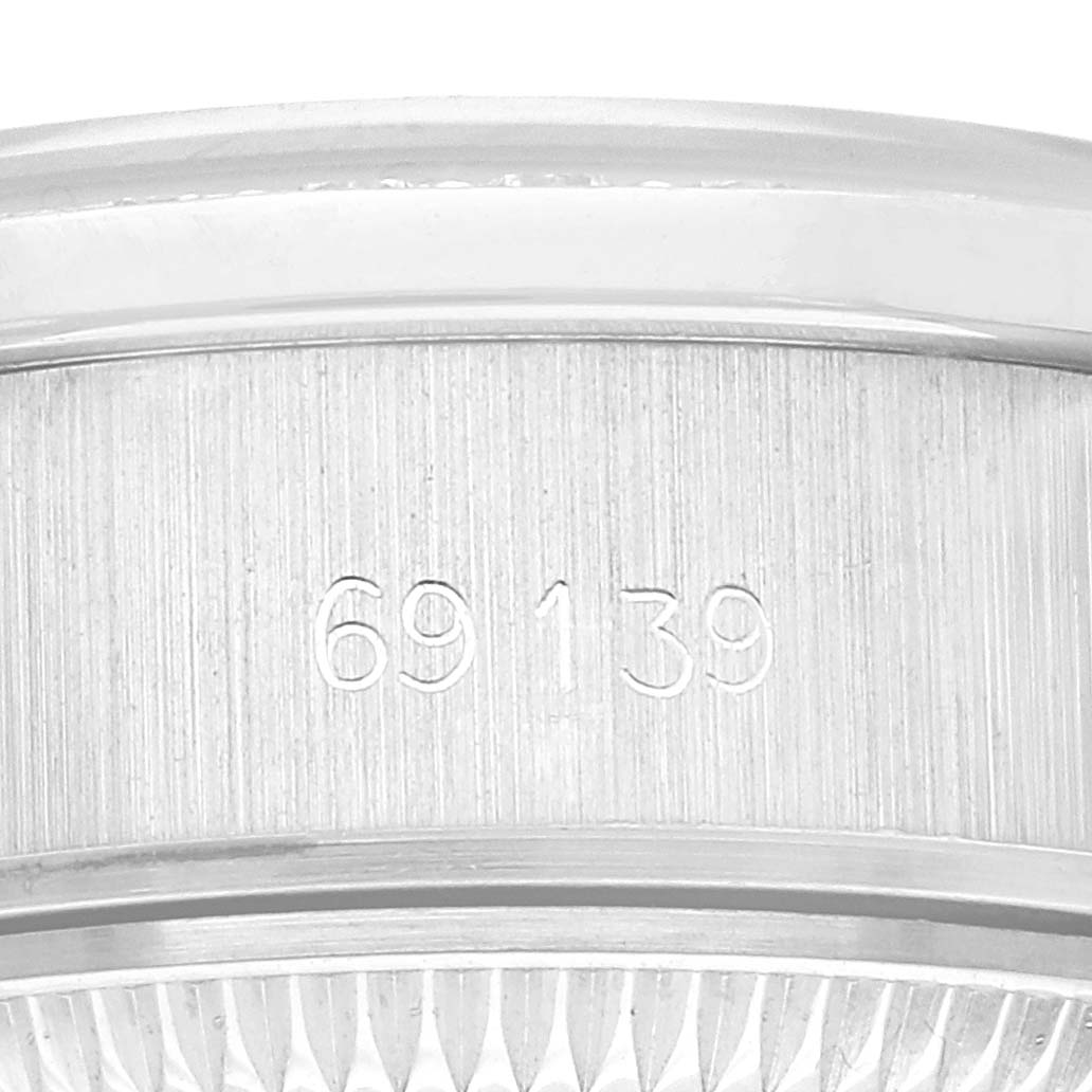 The image shows a close-up of the serial number engraved on the case of a Rolex President 69139 Women's White Gold Silver Dial 69139 Women's White Gold Silver Dial model watch.