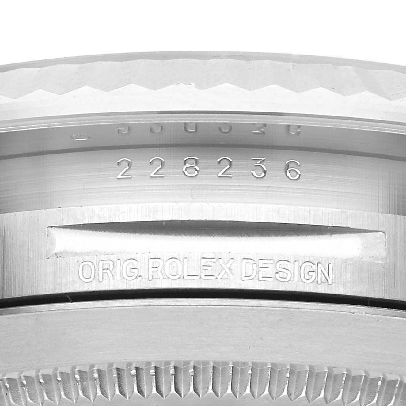 This image shows a close-up of the engraved serial number and "Orig. Rolex Design" on the case of a Rolex President 228236 Men's Platinum Black Dial 228236 Men's Platinum Black Dial model watch.