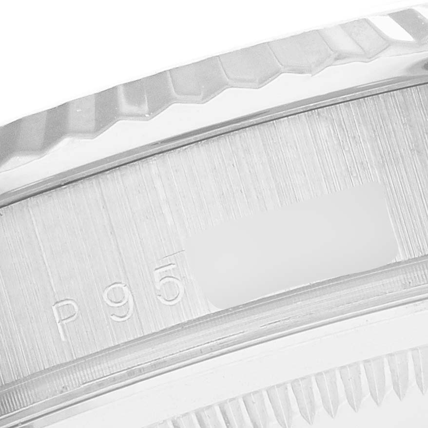 This close-up image shows the engraved serial number and part of the bezel of a Rolex President 118239 Men's White Gold Silver Dial 118239 Men's White Gold Silver Dial model watch.