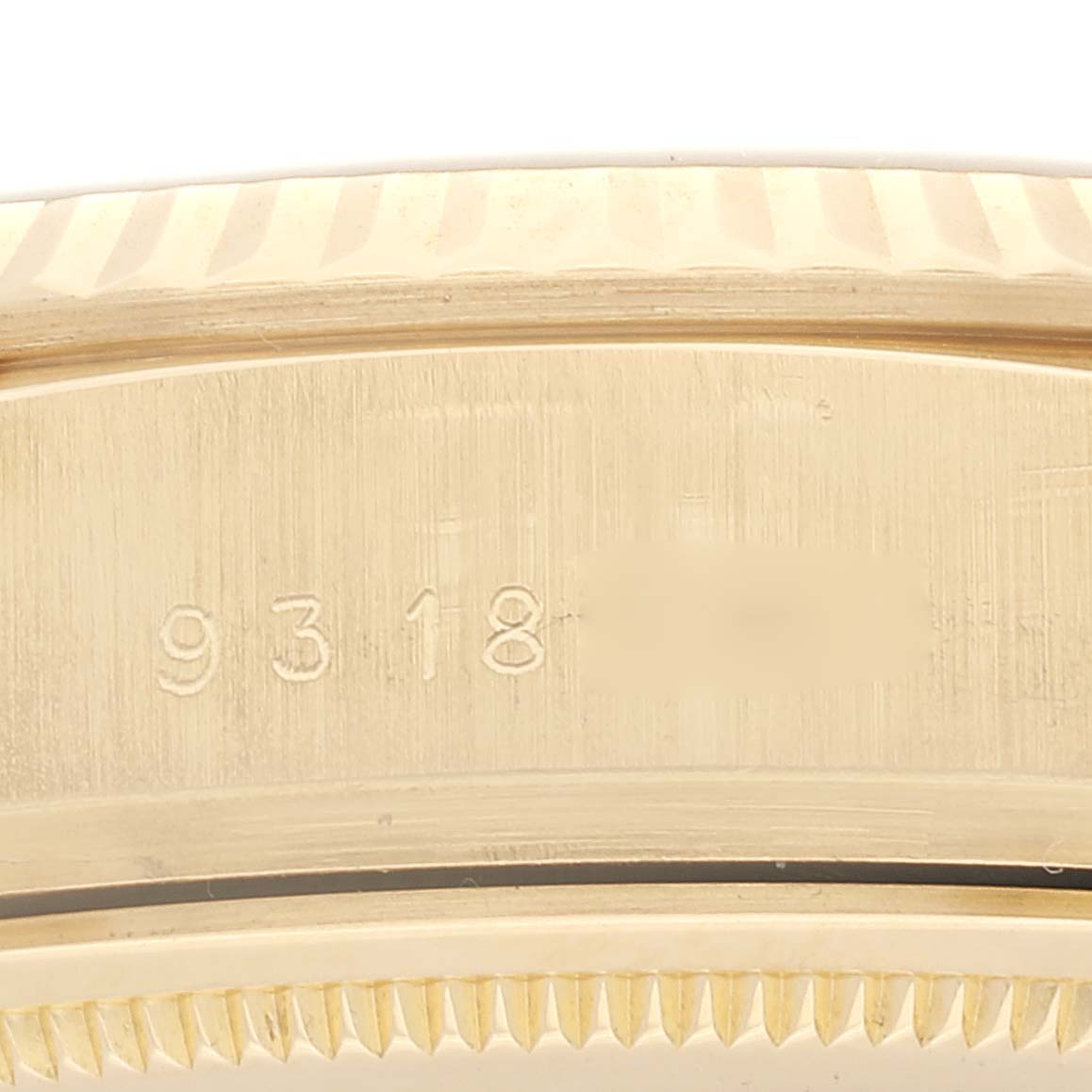 This image shows a close-up of the etched serial number area on a Rolex President 18038 Men
s Yellow Gold Champagne Dial 18038 Men
s Yellow Gold Champagne Dial model watch.