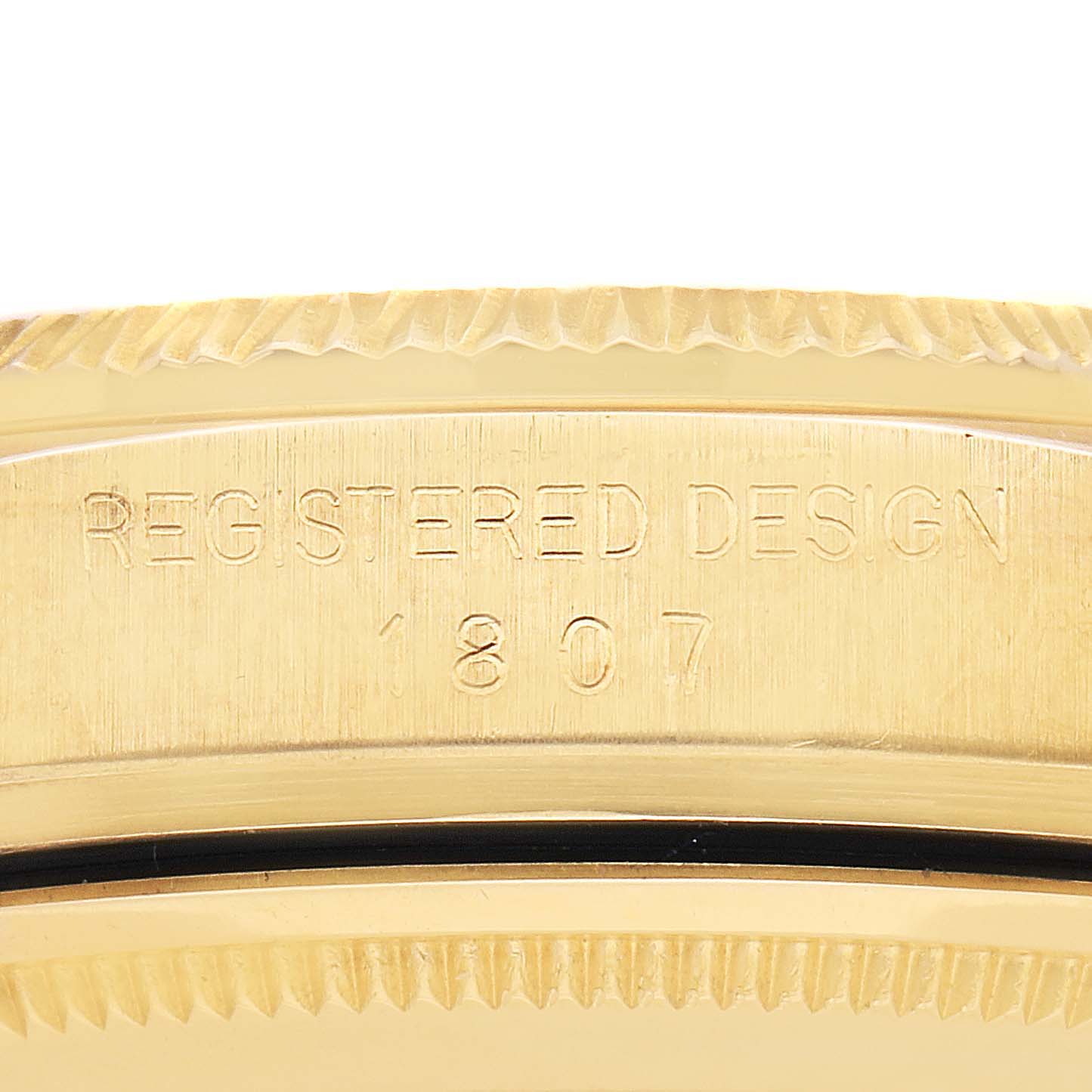 The image shows a close-up of the side of a Rolex President watch, model 1807, highlighting the engraved "REGISTERED DESIGN 1807."