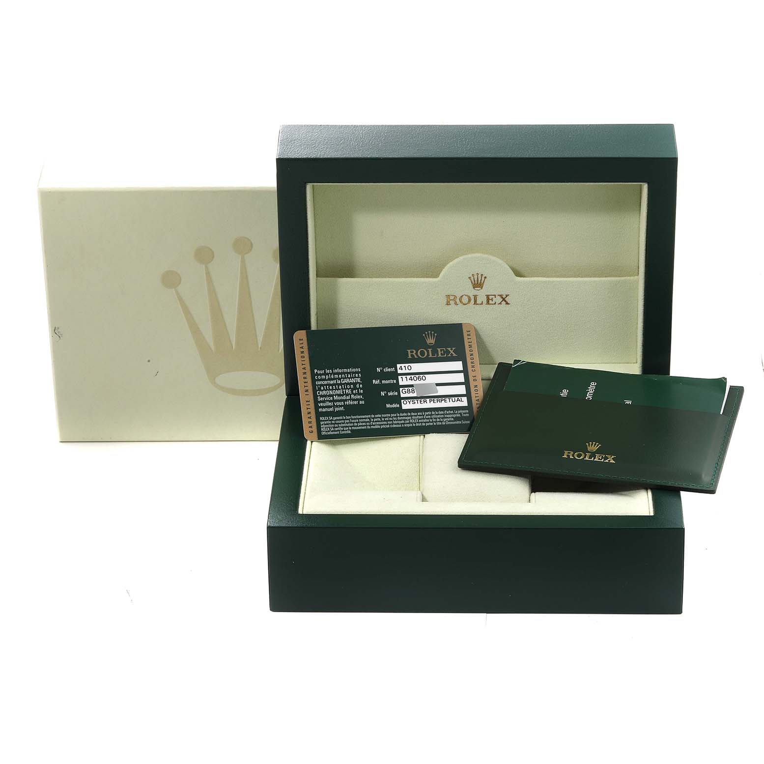 The image shows a Rolex Submariner 114060 Men
s Stainless Steel Black Dial 114060 Men
s Stainless Steel Black Dial watch box and accessories, including the guarantee card and documentation, viewed from the front.