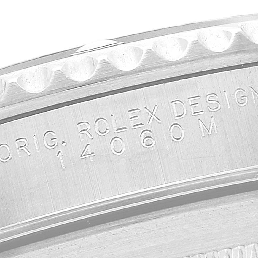 The image shows a close-up of the case back of a Rolex Submariner 14060 Men
s Stainless Steel Black Dial 14060 Men
s Stainless Steel Black Dial watch, highlighting the model number engraved.