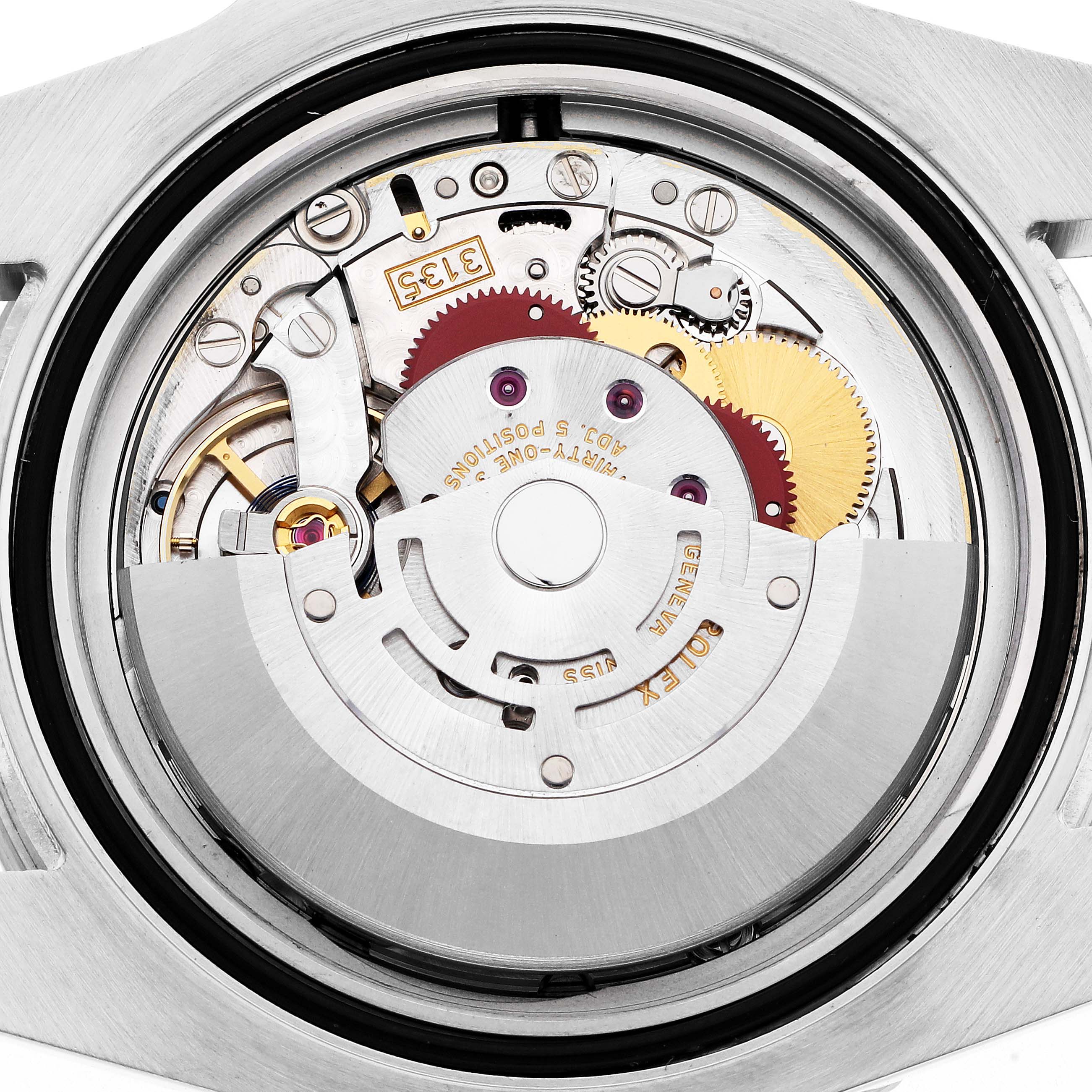 The image shows the movement of a Rolex Submariner model 116610 watch, viewed from the back, highlighting gears and mechanical components.