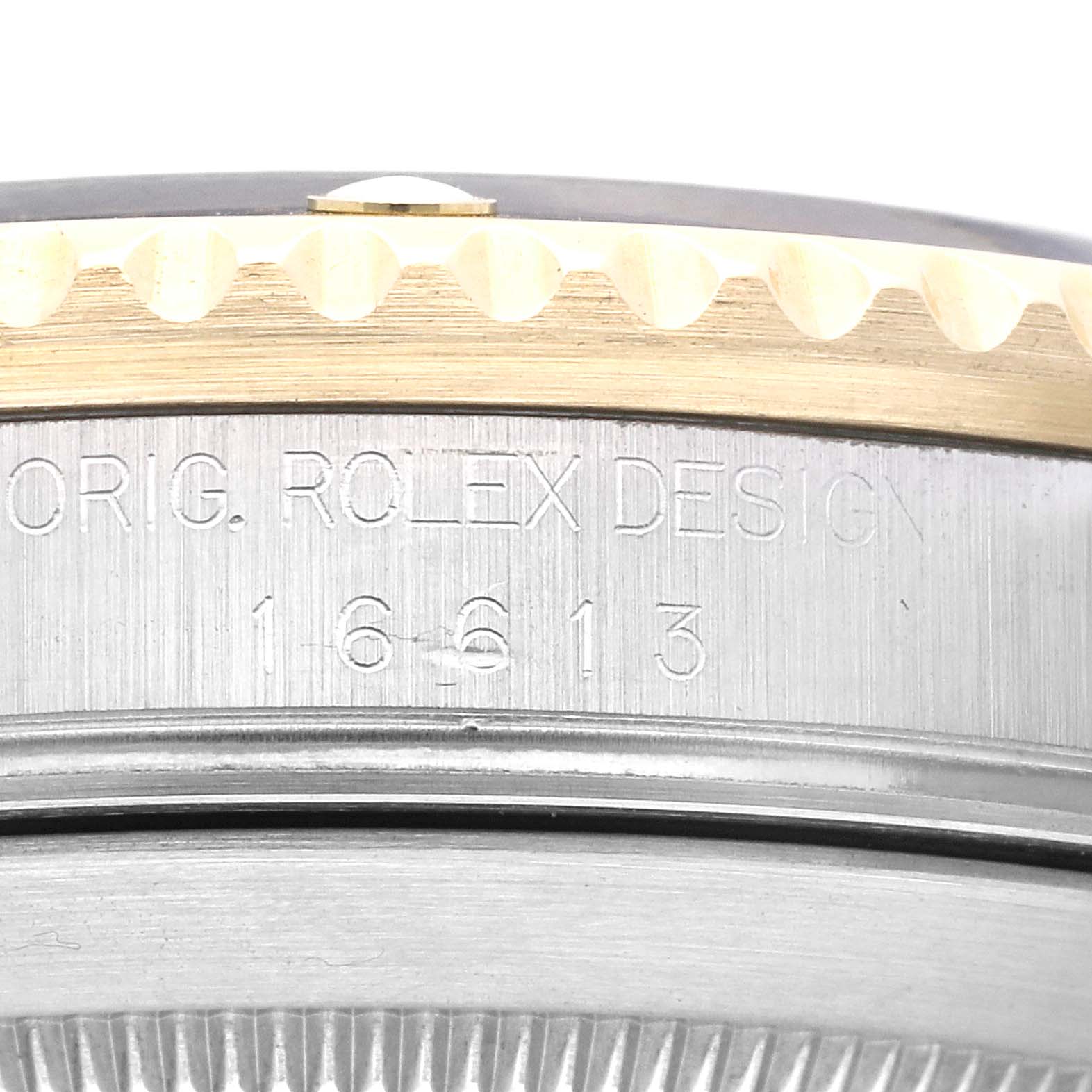 This close-up angle shows the engraved side of the bezel of a Rolex Submariner 16613 Men's Steel and Gold (two tone) Black Dial 16613 Men's Steel and Gold (two tone) Black Dial, highlighting the "16613" model number.