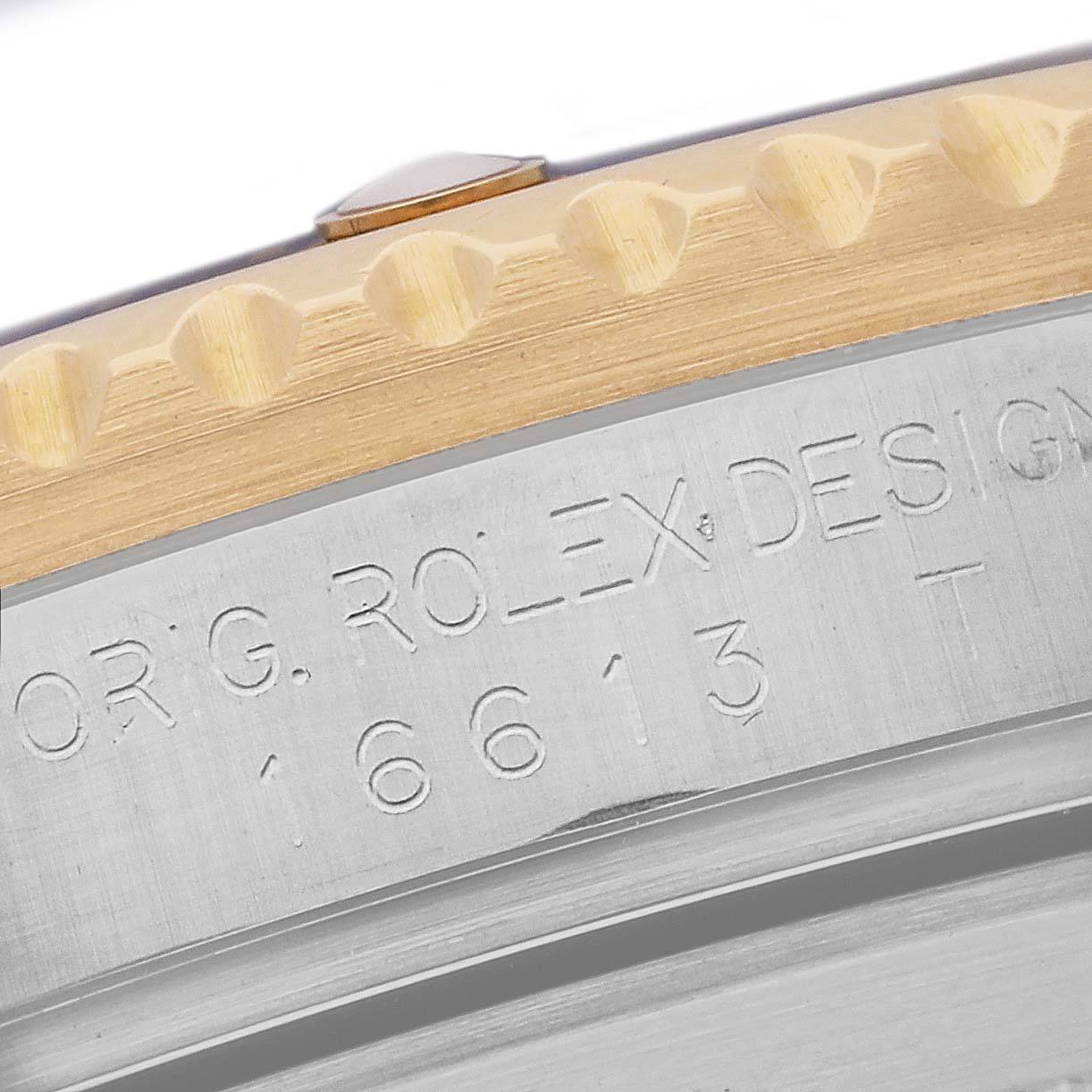 This close-up image shows part of the bezel and the engraved case side of the Rolex Submariner 16613 Men's Steel and Gold (two tone) Grey Dial 16613 Men's Steel and Gold (two tone) Grey Dial watch.