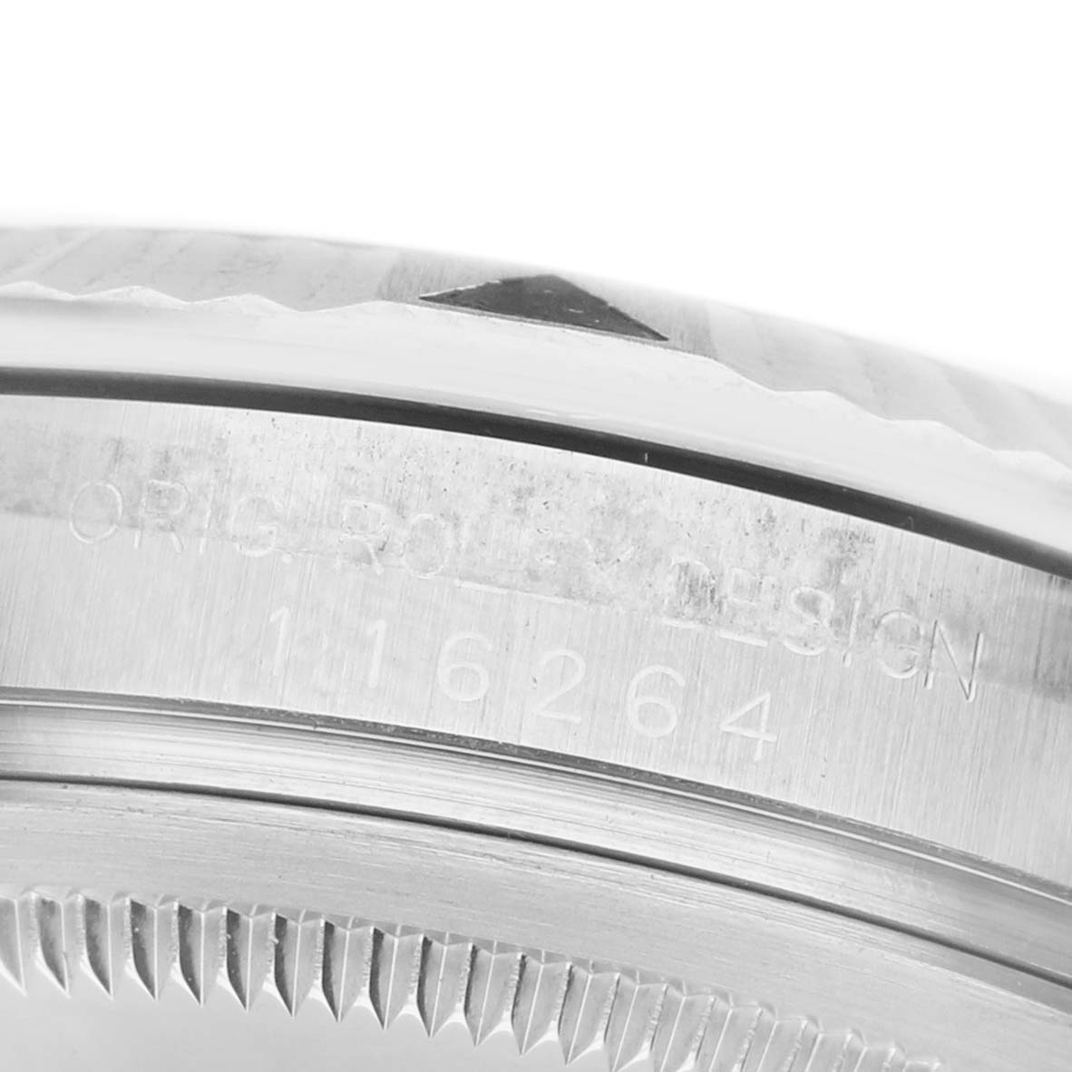 The image shows the side view of a Rolex Turn-o-Graph 116264 Men's Stainless Steel White Dial, focusing on the engraved bezel and case details.