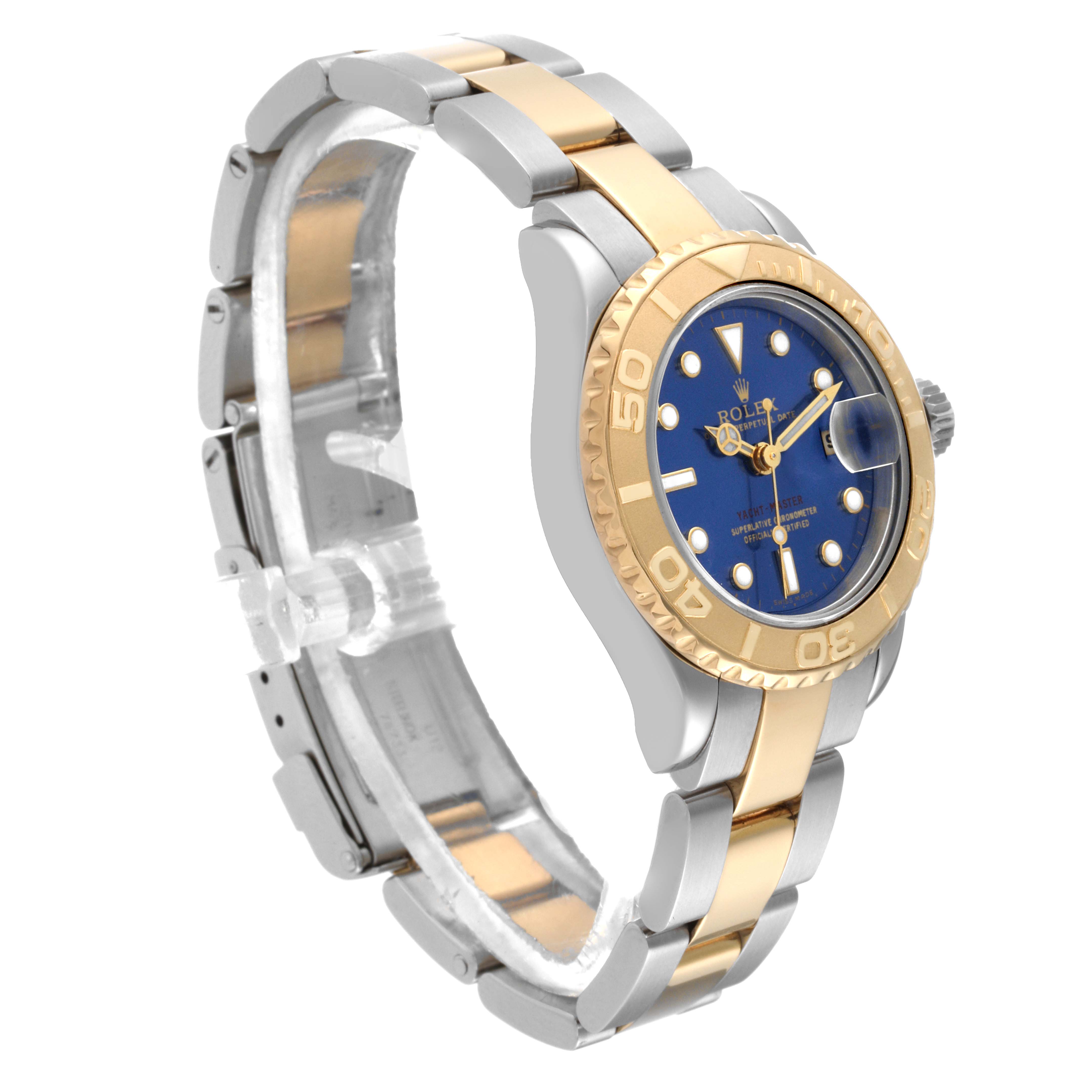 The Rolex Yacht-Master 69623 Women's Steel and Gold (two tone) Blue Dial 69623 Women's Steel and Gold (two tone) Blue Dial watch is shown in a diagonal angle, highlighting its blue dial, gold bezel, and two-tone bracelet.