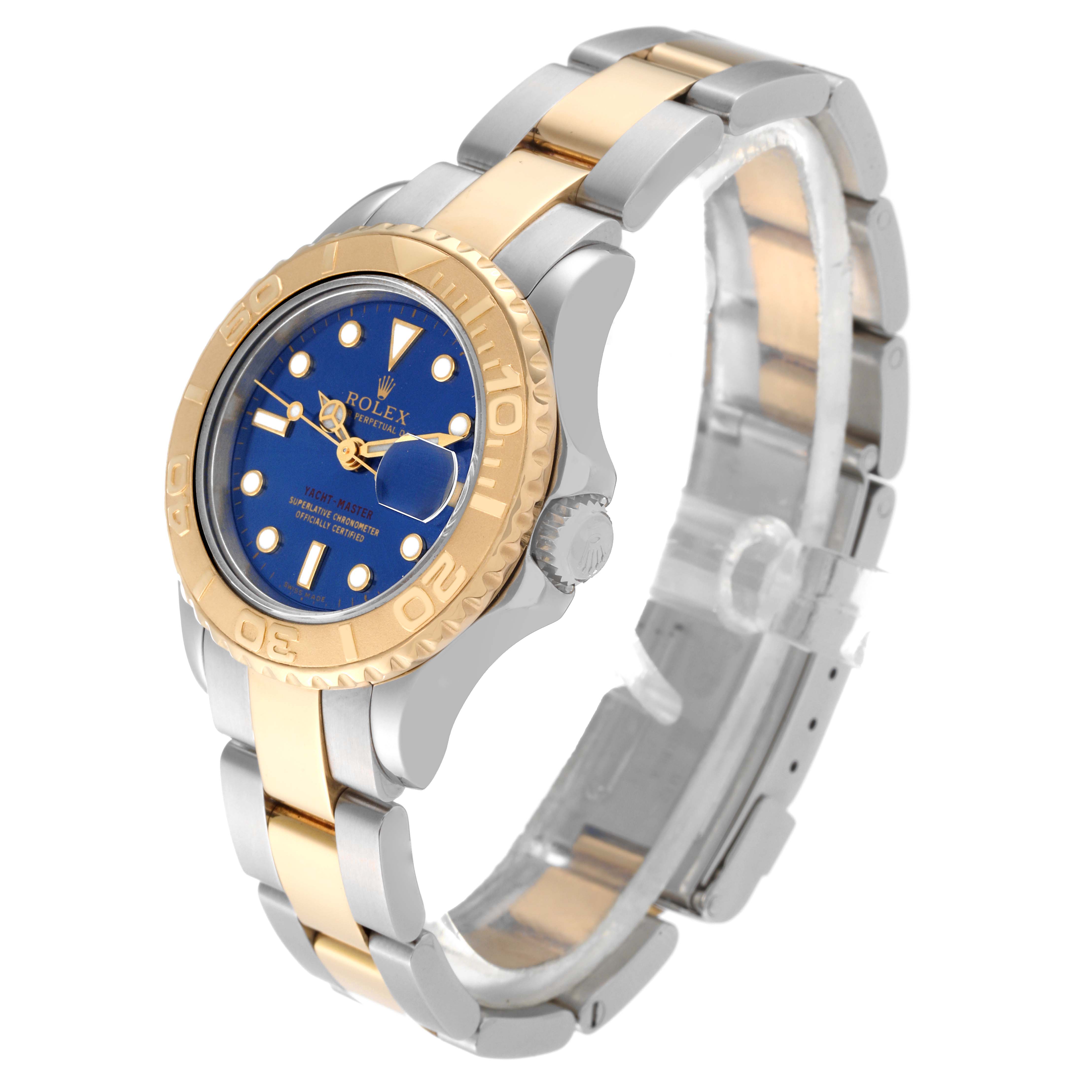 The image shows a Rolex Yacht-Master 69623 Women's Steel and Gold (two tone) Blue Dial 69623 Women's Steel and Gold (two tone) Blue Dial watch angled to display its blue dial, two-tone bracelet, and bezel.