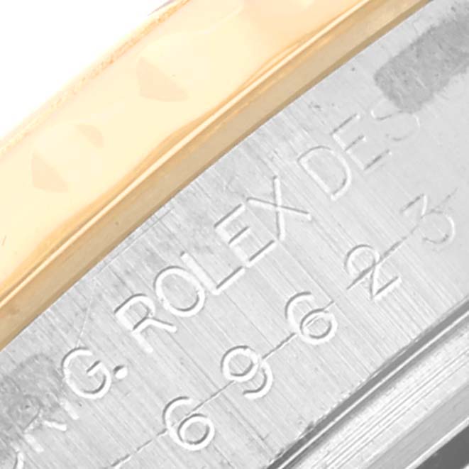 This close-up image shows part of the bezel and engraved case side of a Rolex Yacht-Master 69623 Women's Steel and Gold (two tone) Blue Dial 69623 Women's Steel and Gold (two tone) Blue Dial watch.
