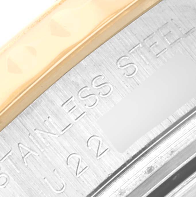 Close-up of the rim and back case of the Rolex Yacht-Master 69623 Women's Steel and Gold (two tone) Blue Dial 69623 Women's Steel and Gold (two tone) Blue Dial watch, showing "STAINLESS STEEL" engraving.