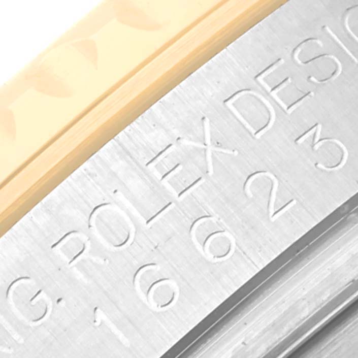 This close-up angle of the Rolex Yacht-Master 16623 Men's Steel and Gold (two tone) White Dial 16623 Men's Steel and Gold (two tone) White Dial model shows the side engraving on the metal bezel.