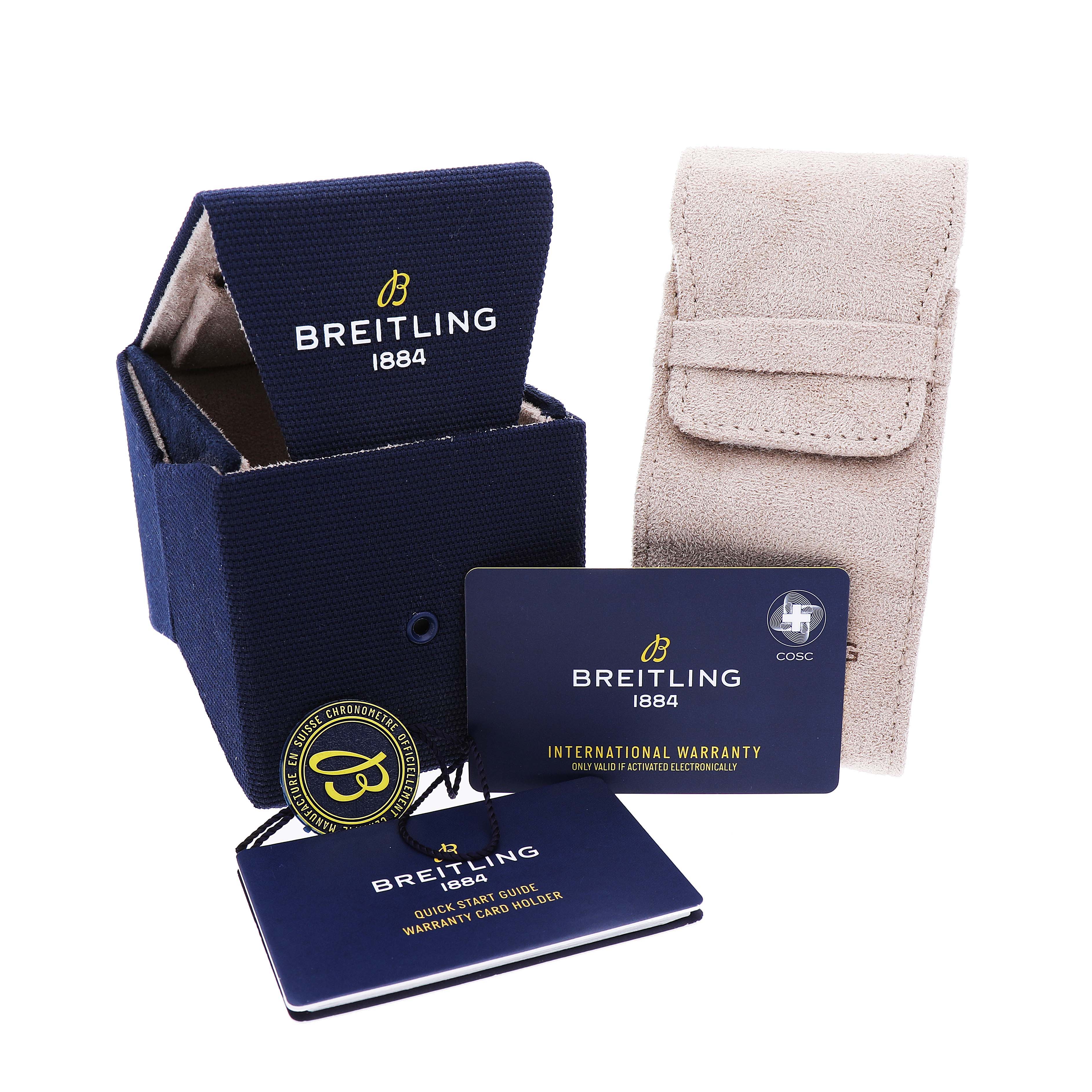 The image shows a Breitling Avenger S32320 Men's Ceramic Black Dial watch's packaging, including a blue box, a suede pouch, a warranty card, and a booklet.
