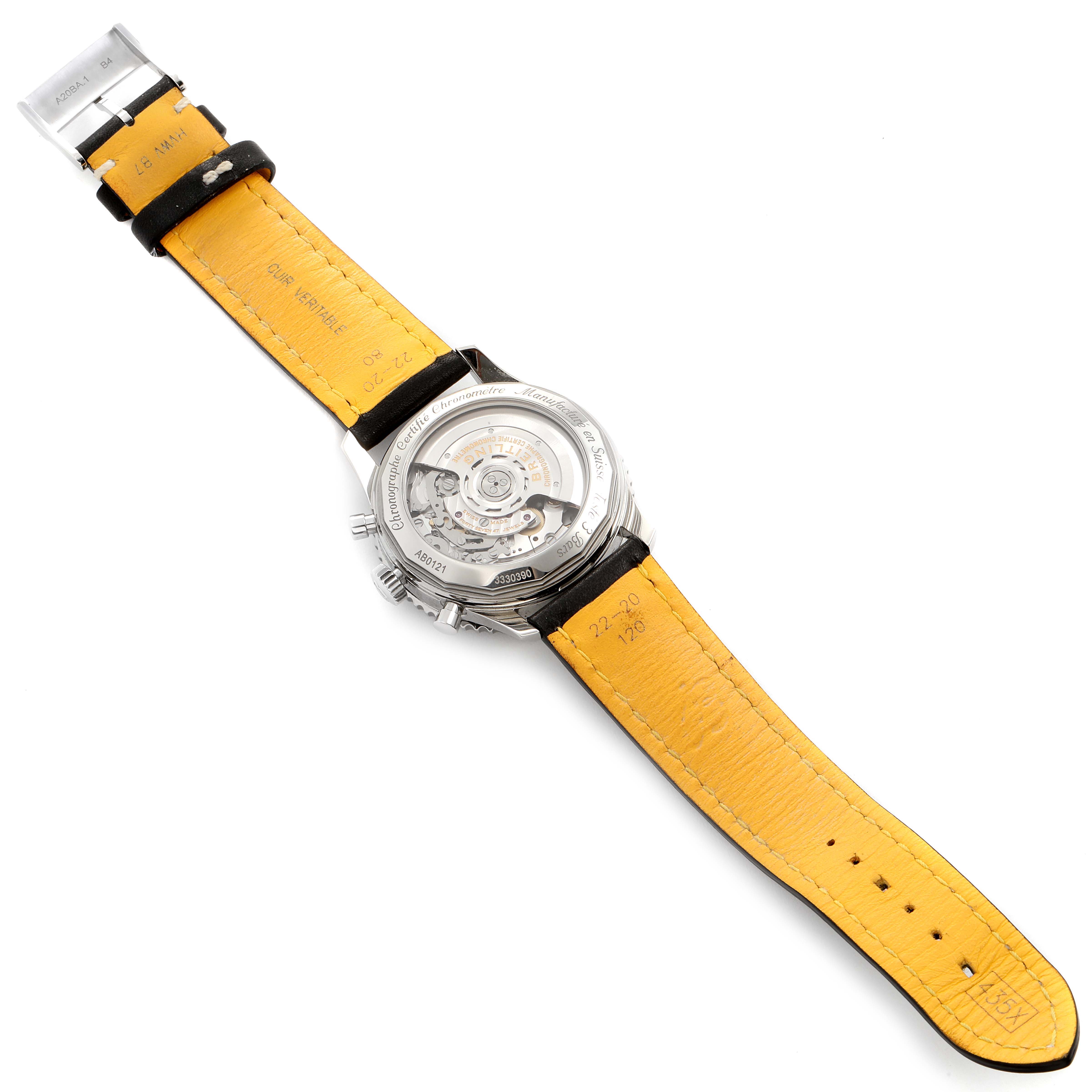 This image shows the Breitling Navitimer AB0121 Men's Stainless Steel Black Dial AB0121 Men's Stainless Steel Black Dial watch from the back, highlighting its transparent case back and yellow leather strap.