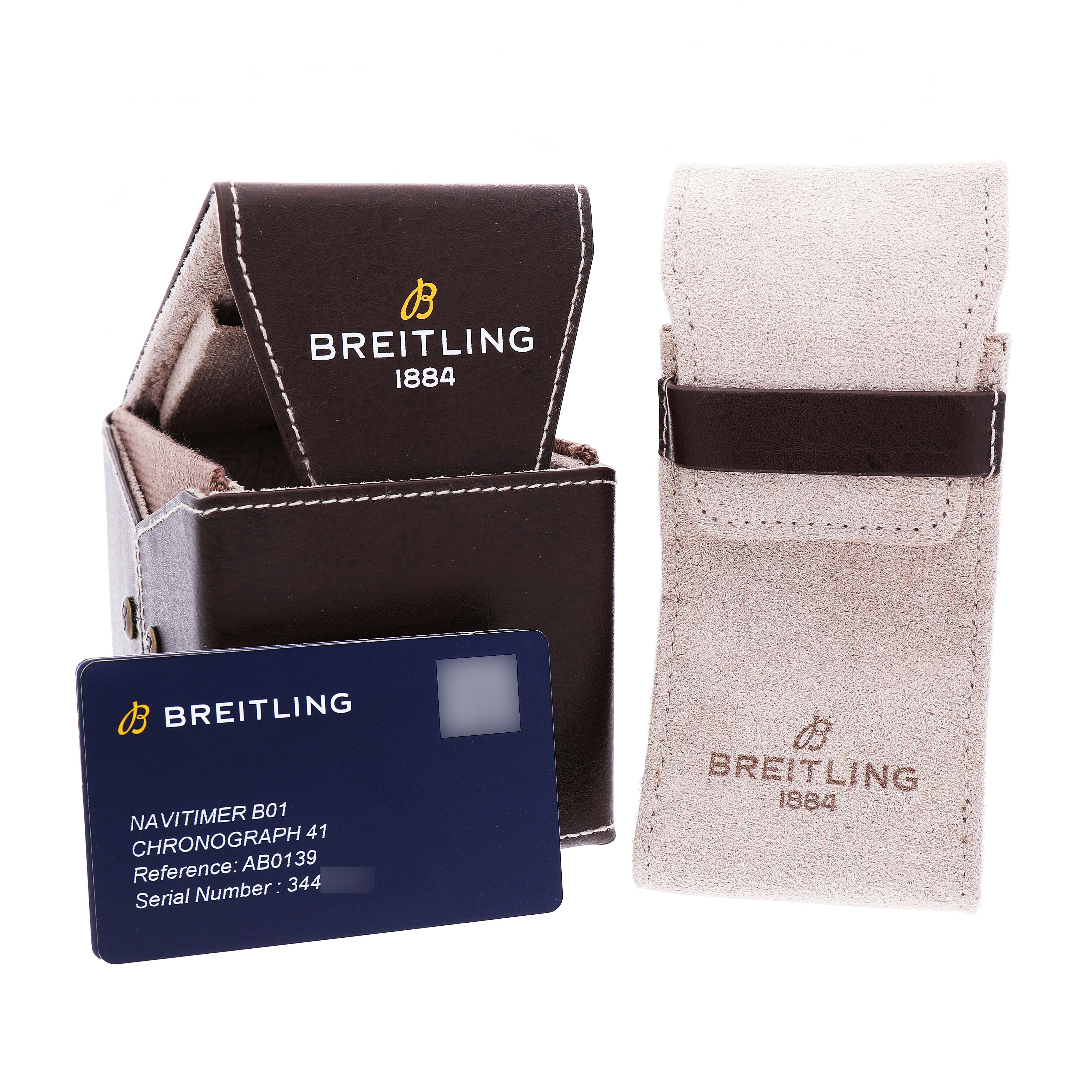 The image shows the packaging and accessories for a Breitling Navitimer AB0139 Men's Stainless Steel Blue Dial, including a box, pouch, and information card.