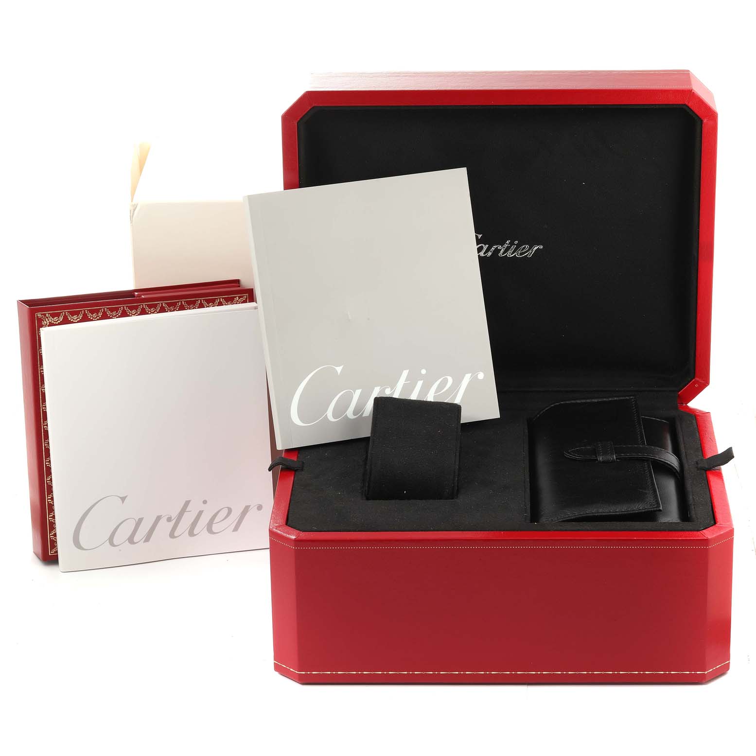 This image shows the box and accessories for the Roadster model by Cartier, including manuals, a cushion, and a leather pouch.
