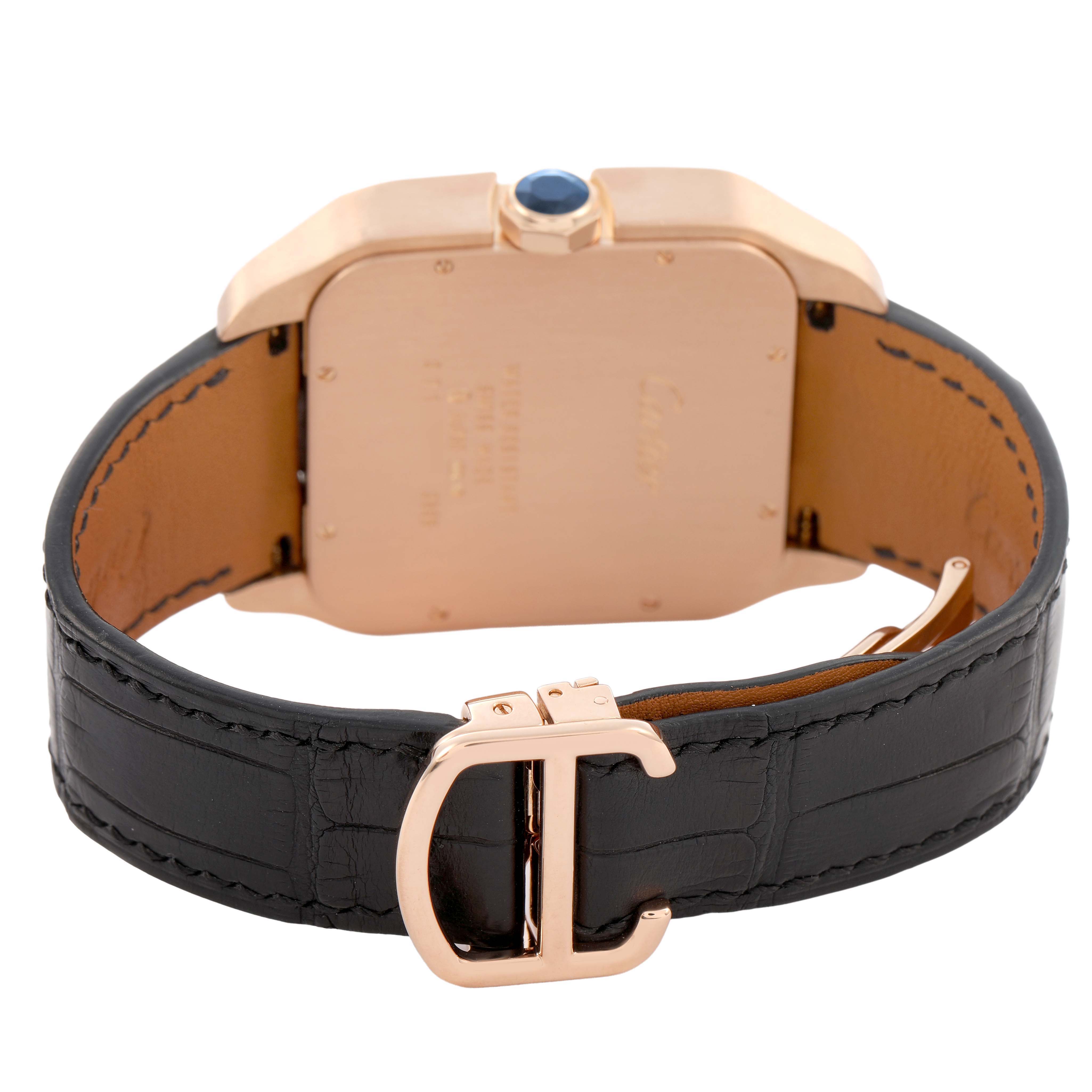 The image shows the back view of a Cartier Santos Dumont W2020068 Men's Rose Gold Grey Dial watch, highlighting the case, crown with a blue stone, and black leather strap with a buckle.