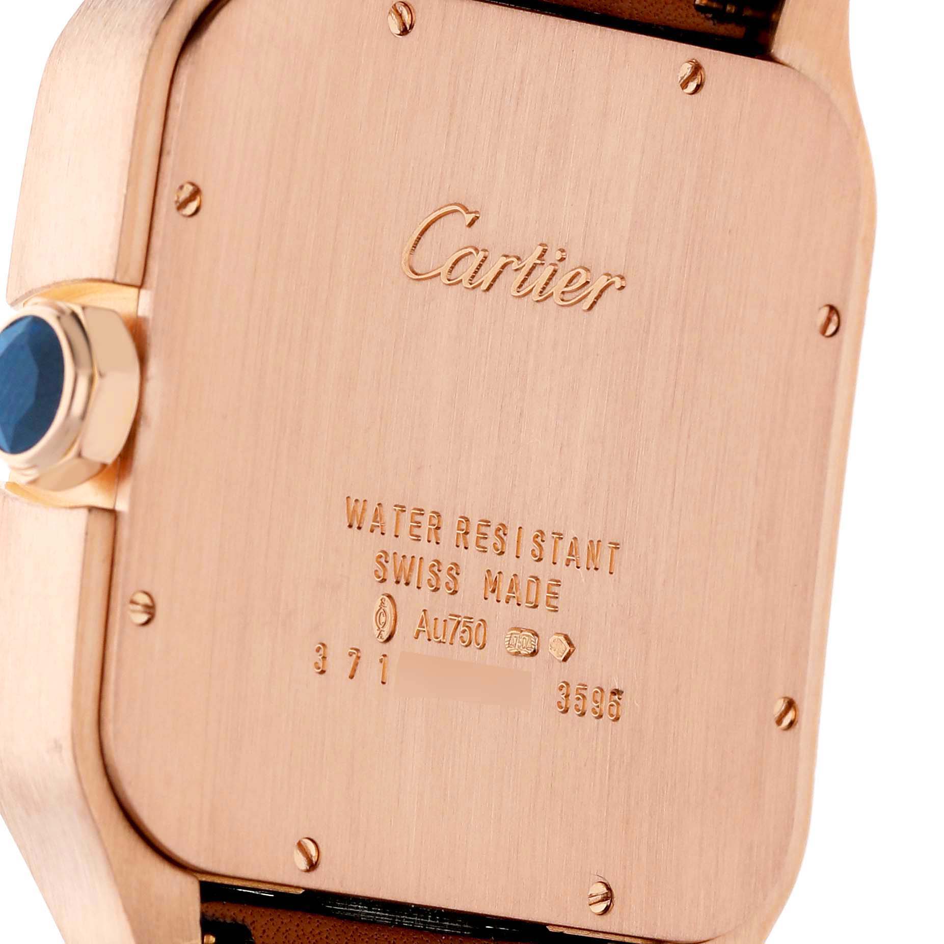 The image shows the case back and crown of the Cartier Santos Dumont W2020068 Men's Rose Gold Grey Dial watch at an angled view, highlighting its inscriptions.