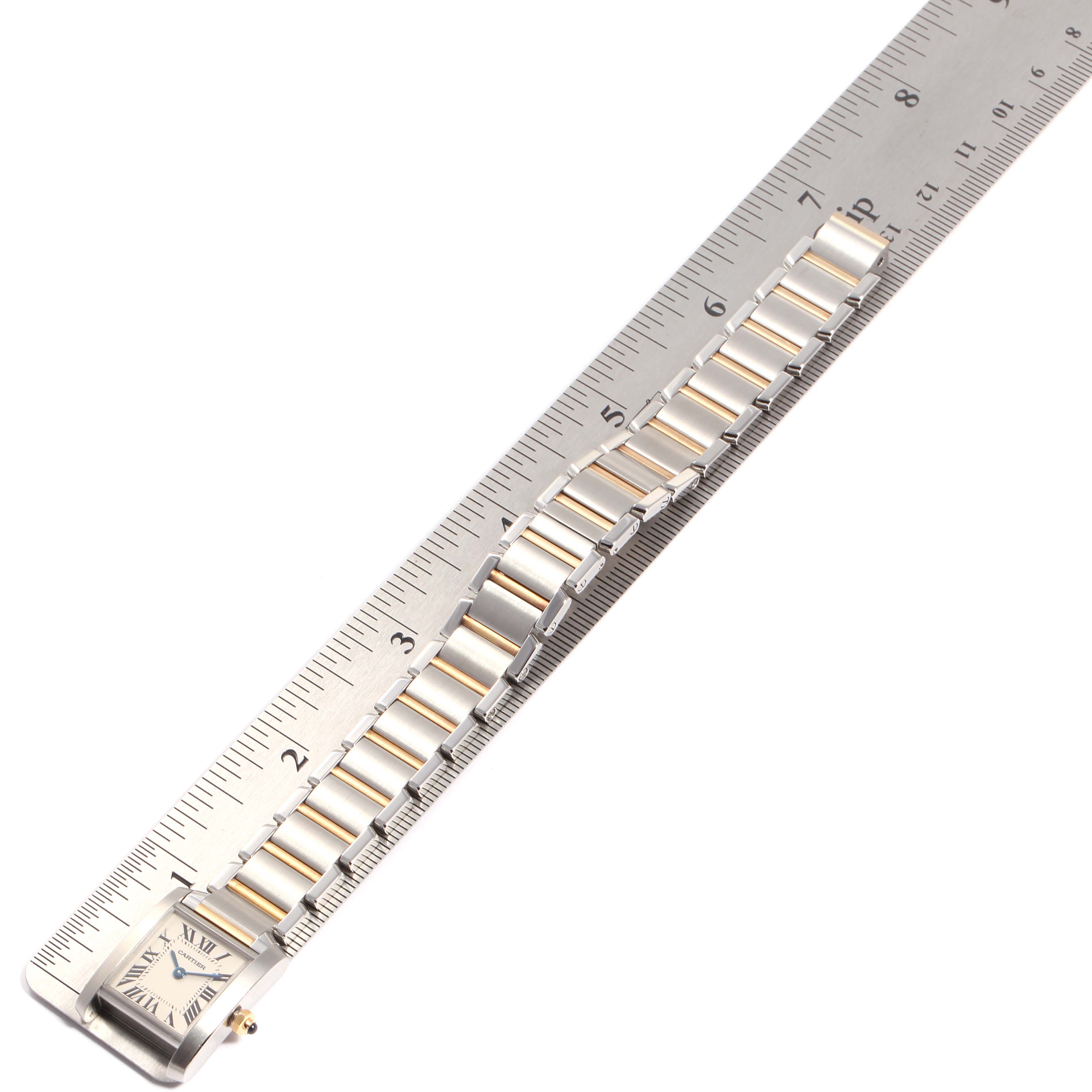 The Tank Francaise by Cartier is shown from a top-down angle with a focus on the watch's face and the full length of its bracelet.