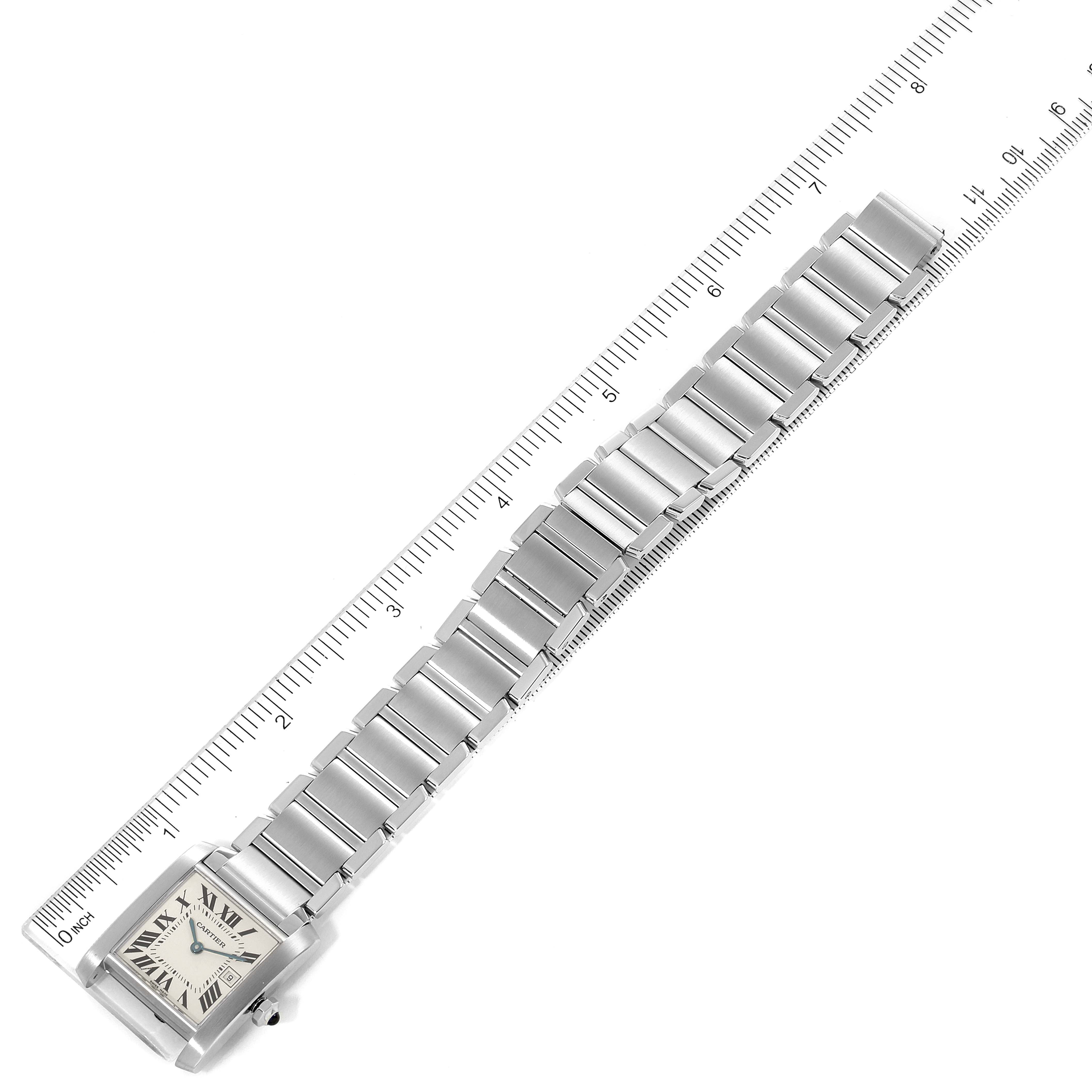 The image shows a top-down view of the Cartier Tank Française watch, highlighting its face and stainless steel bracelet next to a ruler.