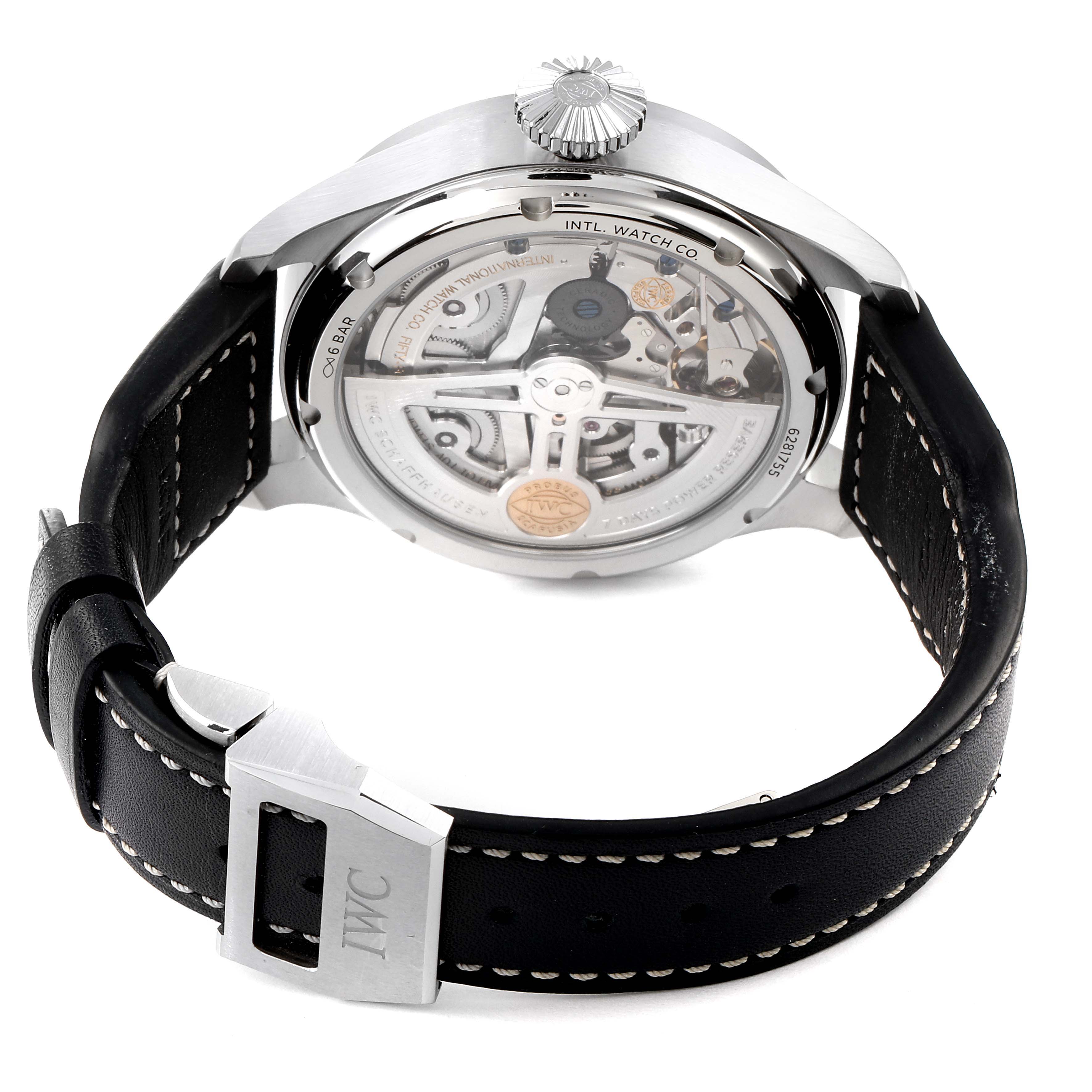 The image shows the back view of an IWC Pilot IW503605 Men's Stainless Steel Blue Dial IW503605 Men's Stainless Steel Blue Dial watch, displaying its transparent case back and inner mechanisms, along with a black leather strap and stainless steel buckle.